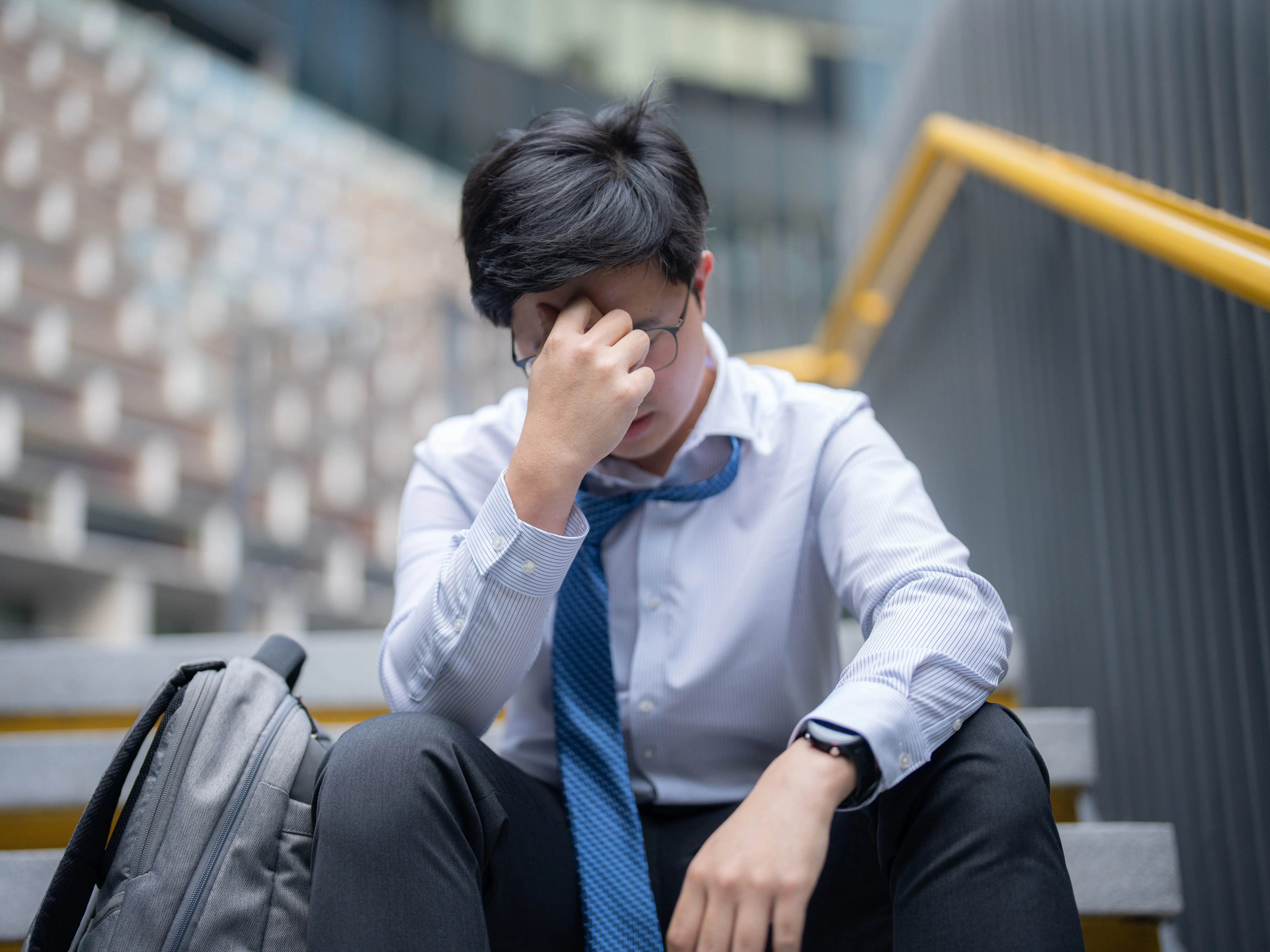 Man sitting with head in hands