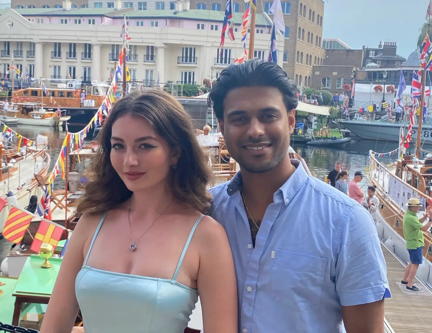 The writer and her partner in London, standing in front of many boats outside.