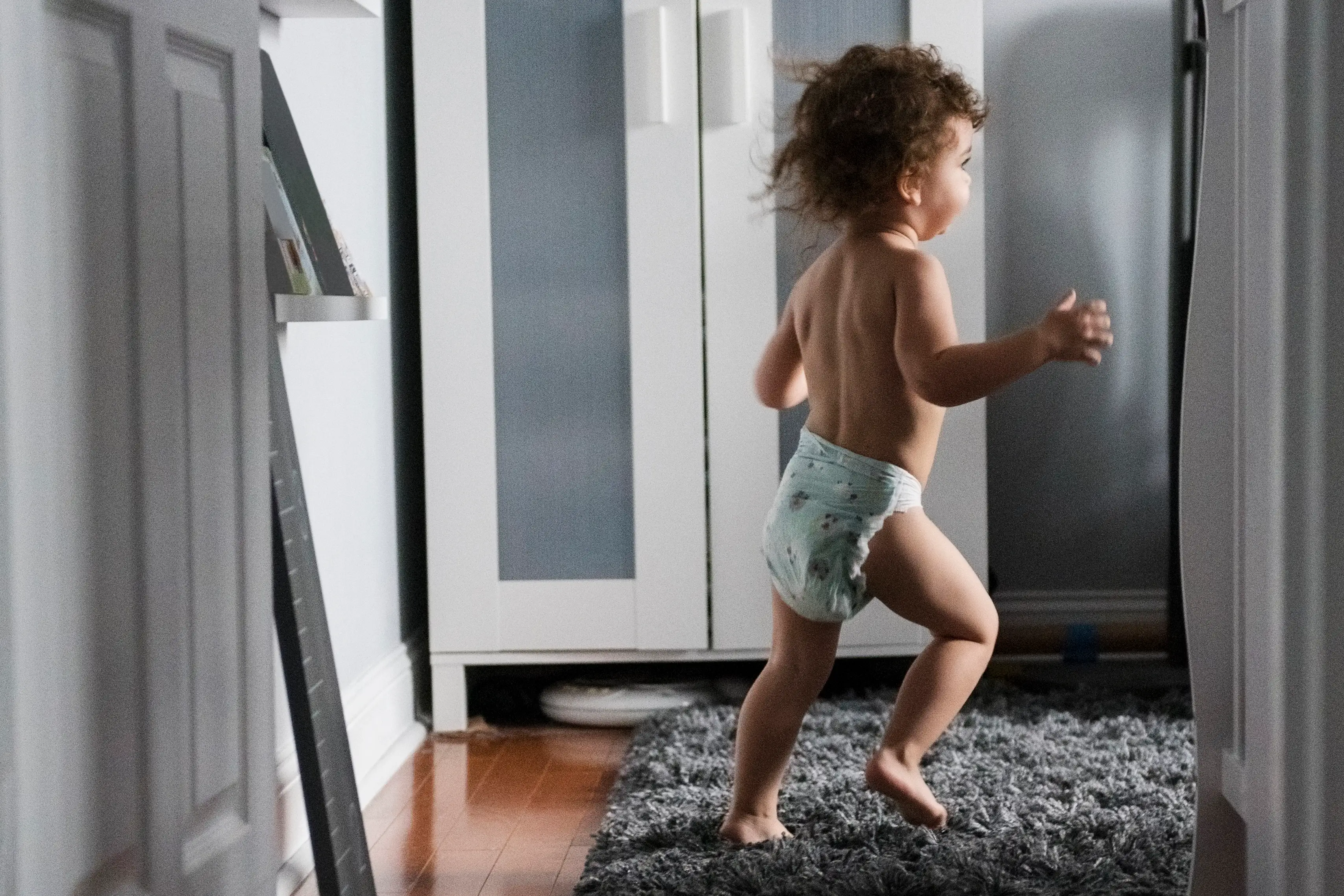 boy wearing diaper running in corridor