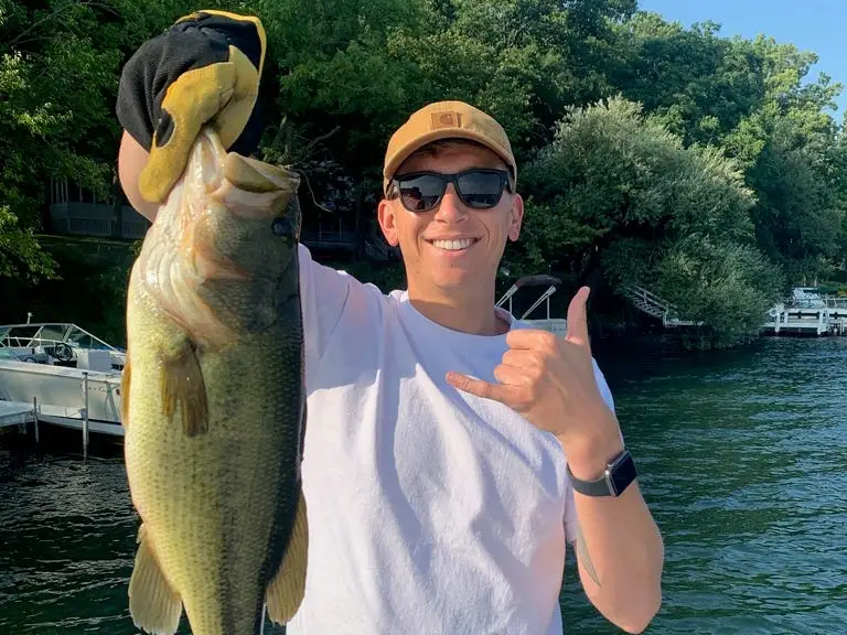 Author Joe Opaleski in Wisconsin holding a fish, wearing sunglasses