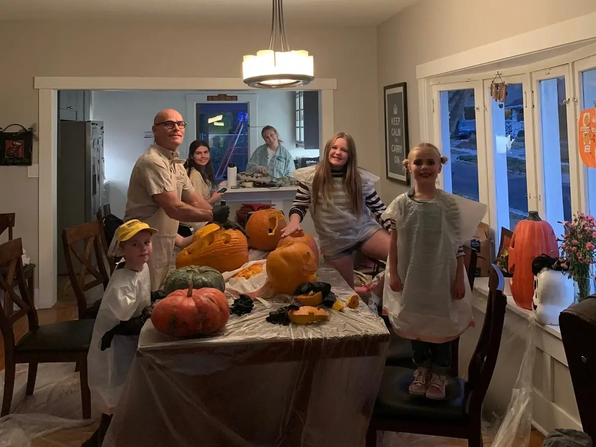 Family carving pumpkins