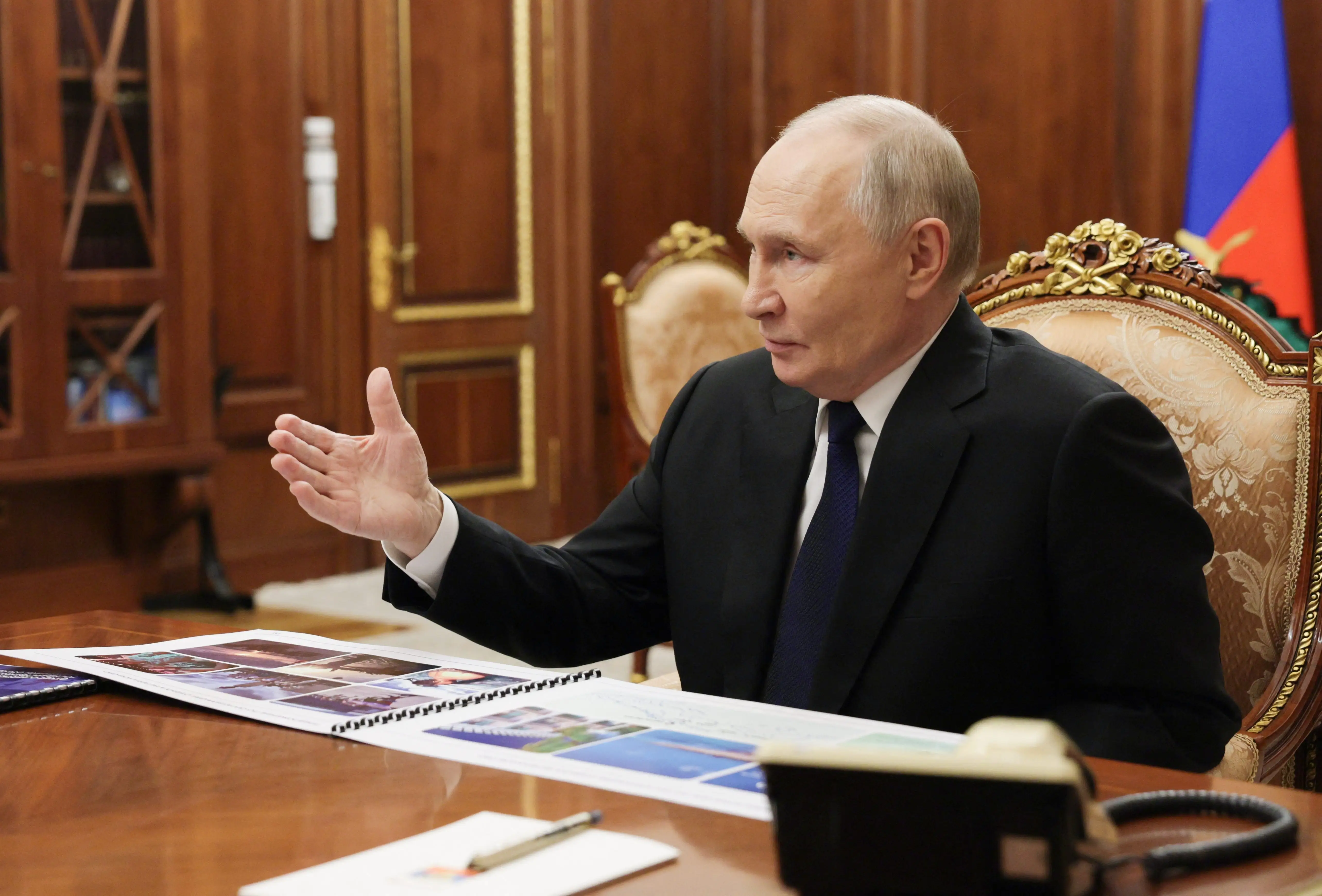 Russian President Vladimir Putin seat speaking.