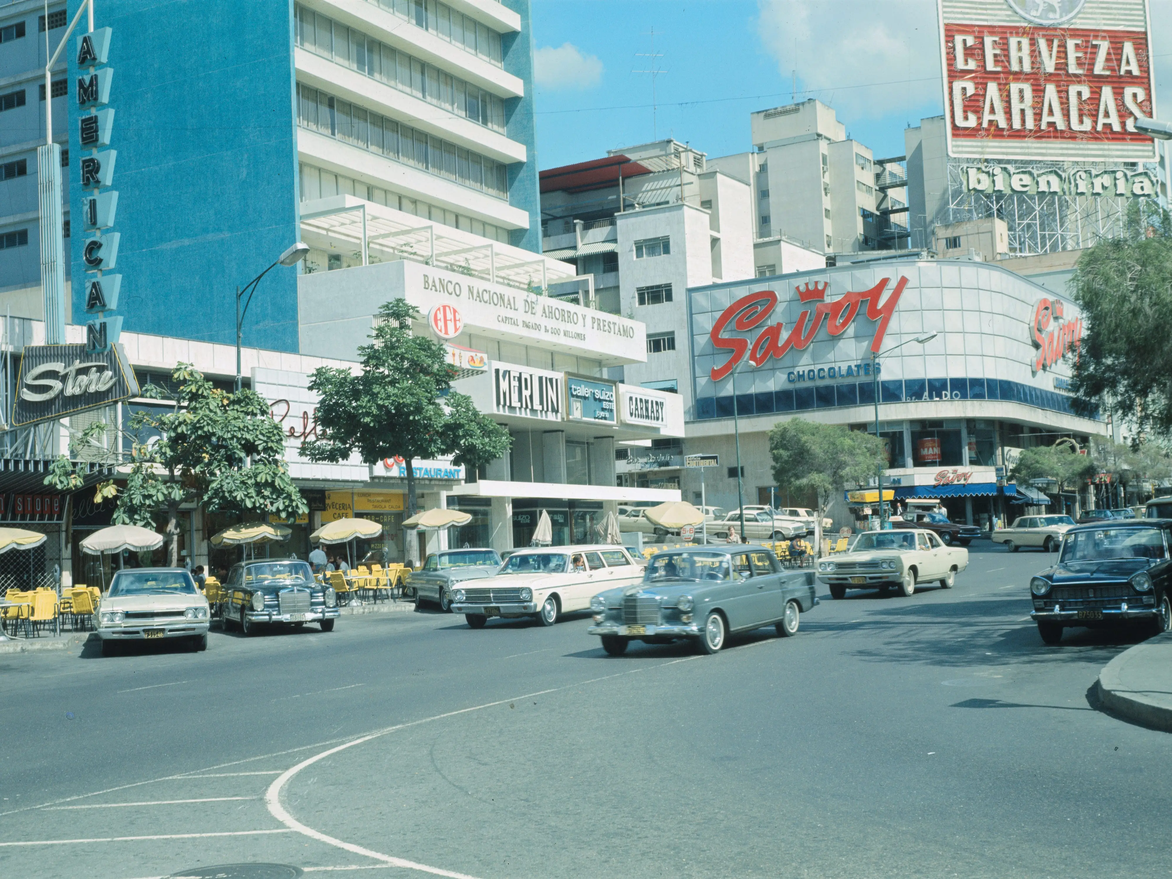 Sabana Grande, Caracas' plush shopping district, is dotted with sidewalk cafes, showing the influence of half a million Spanish and Italian residents here. Photo circa 1969.