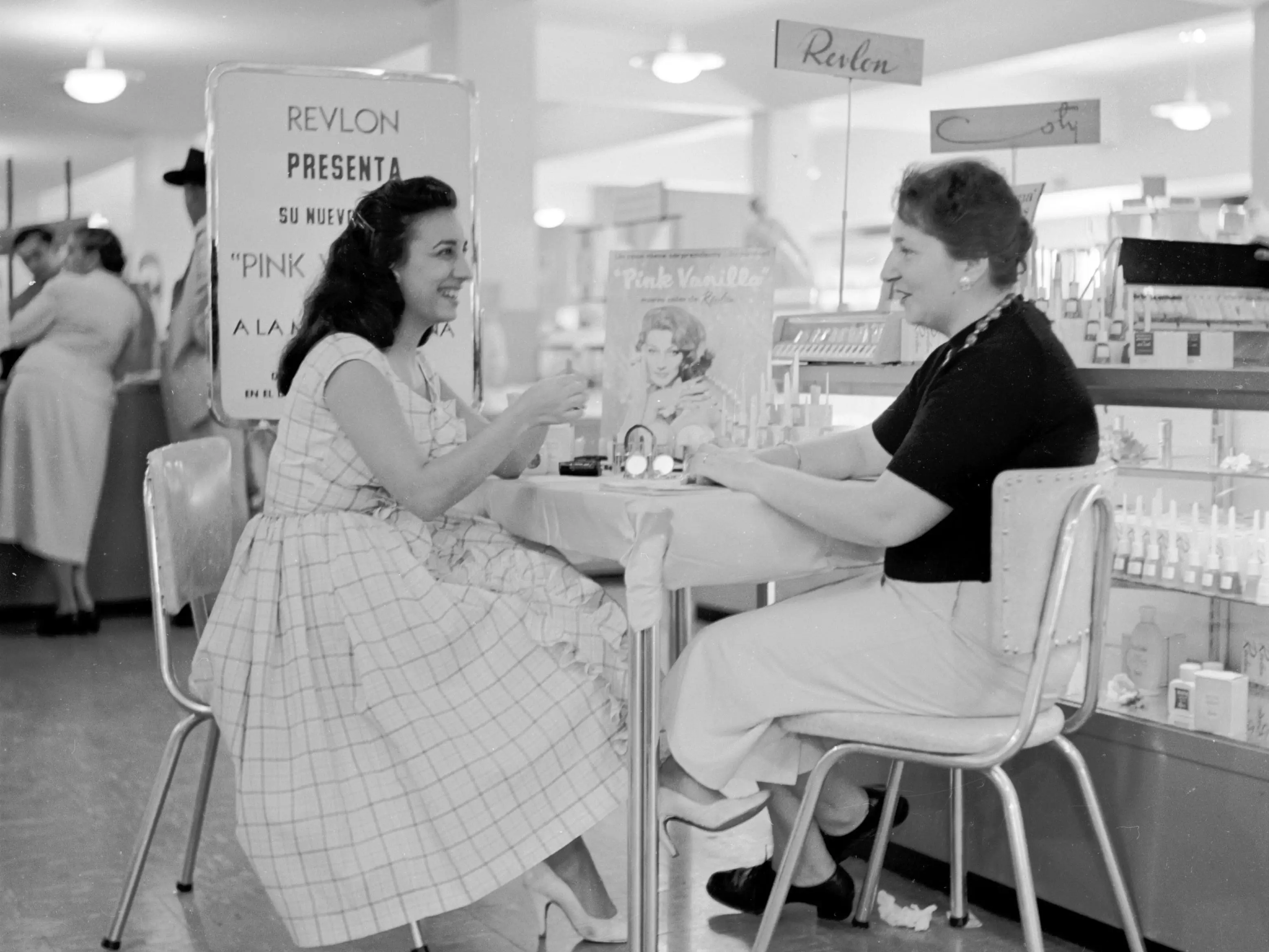 A woman receiving a cosmetic consultation in Sears Roebuck department store, Caracas, Venezuela, circa 1955.