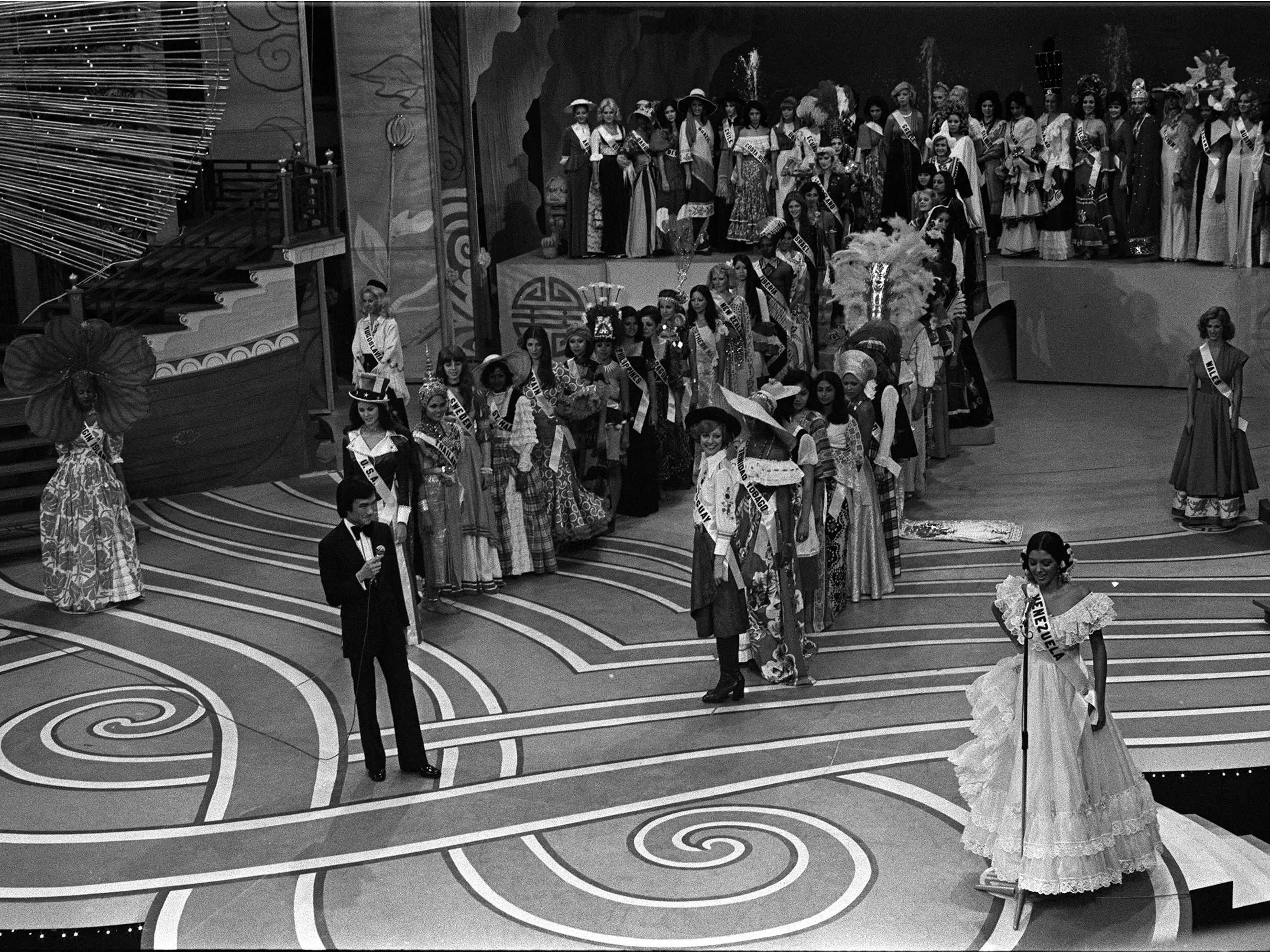 Dressed in her national costume, Miss Venezuela introduces herself on stage at the 1976 Miss Universe Pageant at the Lee Theatre.