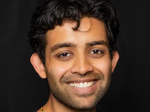headshot of a man with a black background