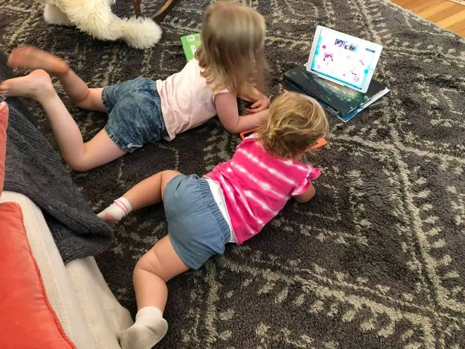 The author's daughters reading with their grandmother on the Readeo app.