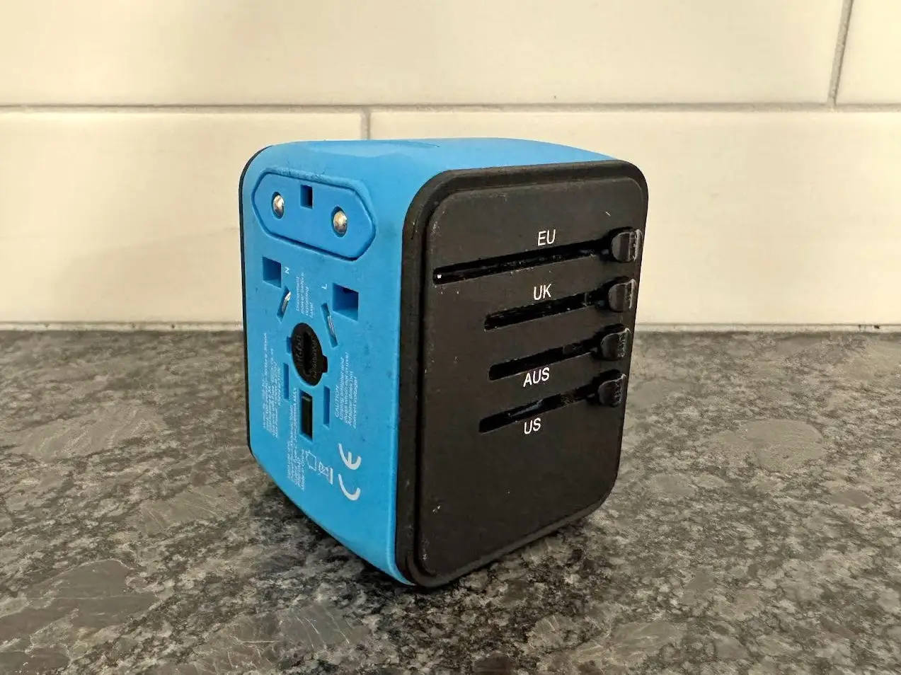 A multi-country power adaptor on a countertop.