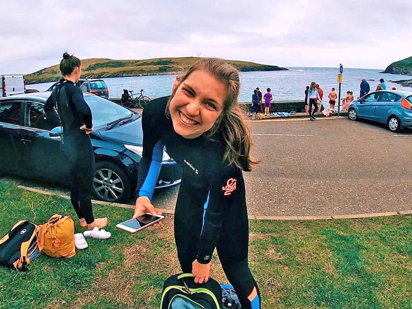Hannah smiles for a photo while wearing a wetsuit.