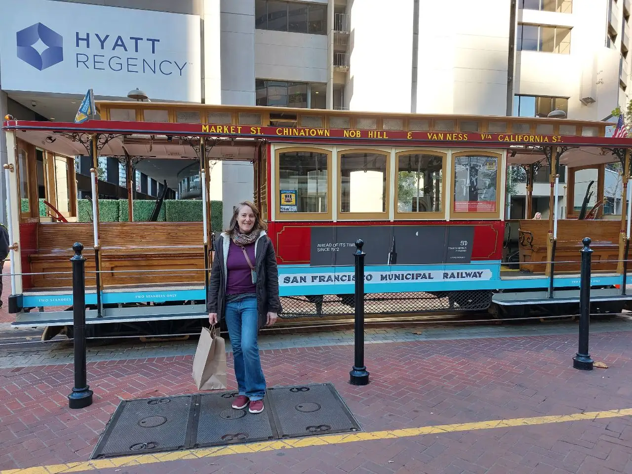 Woman posing with San Francisco trolley