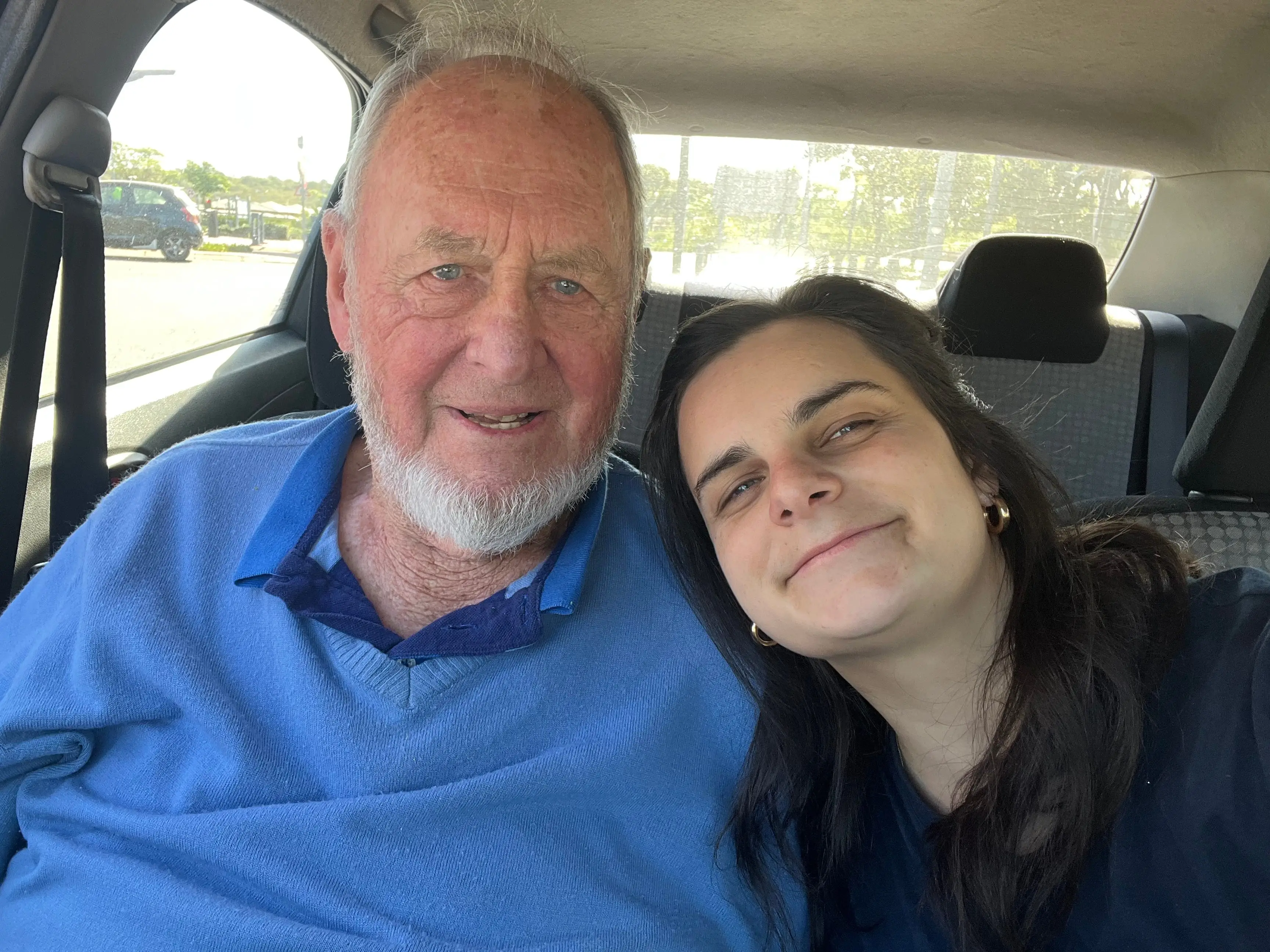 The author with her grandfather sitting in a car.