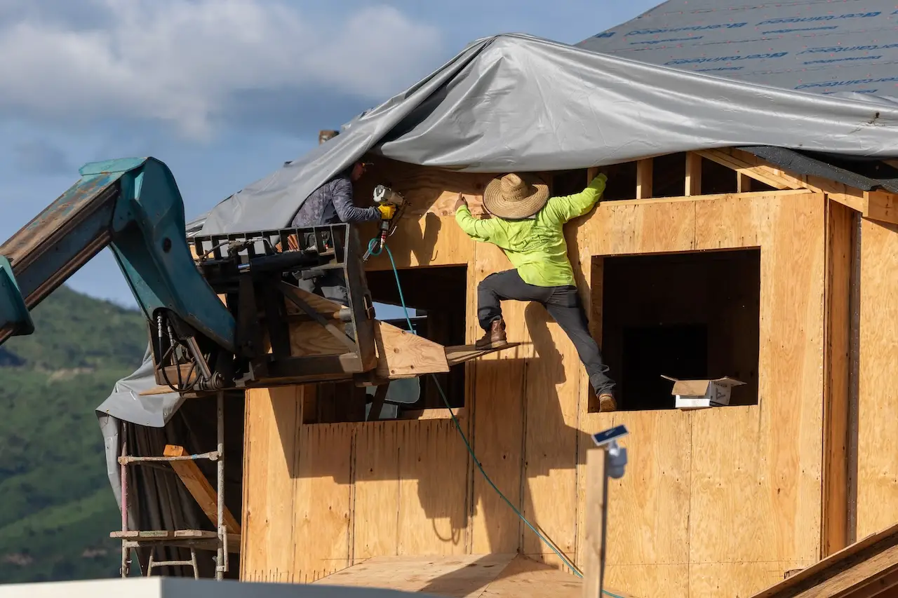 Construction workers build a home in the Palisades fire zone on the one year anniversary in the Pacific Palisades in Los Angeles.