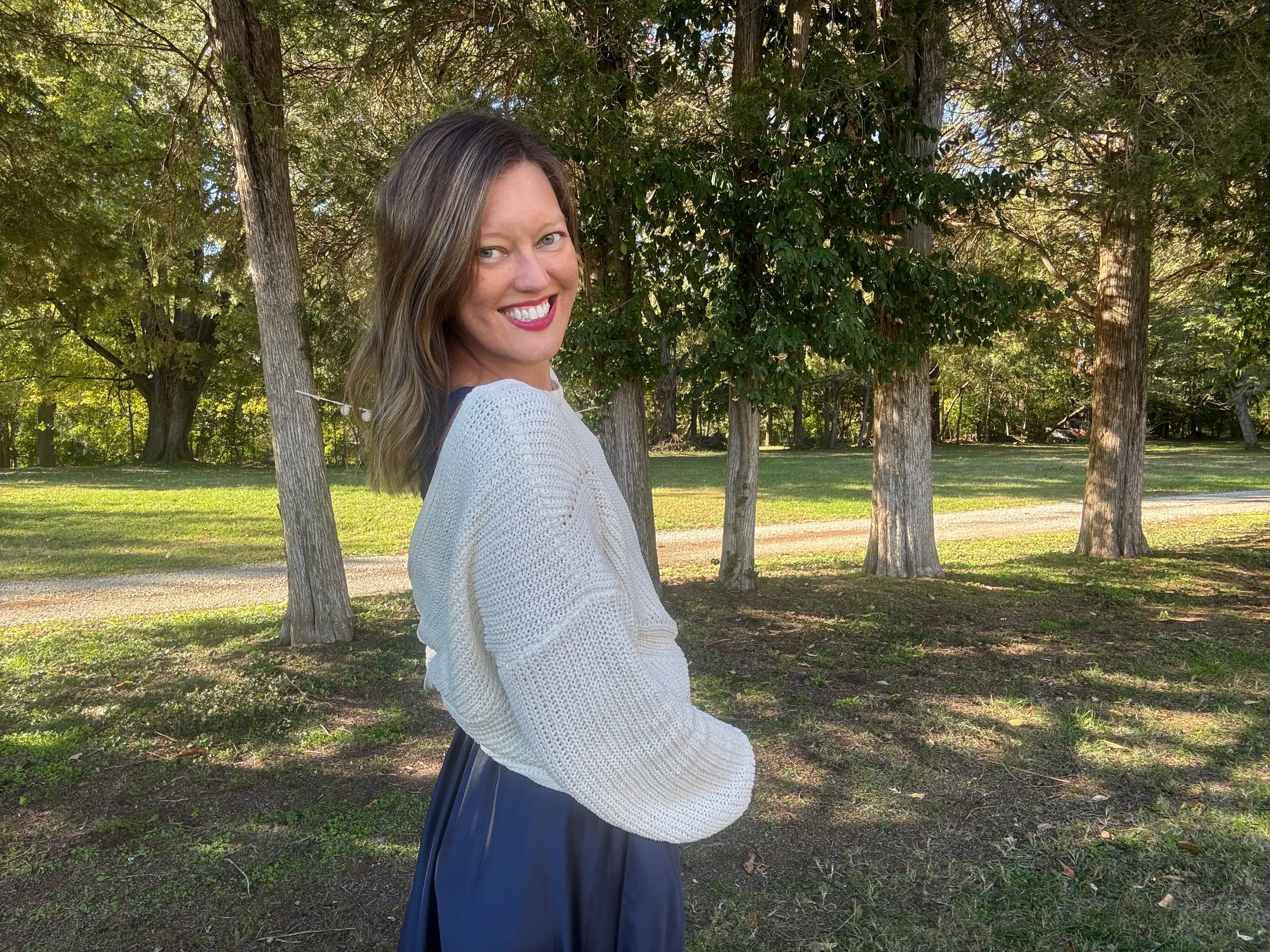 The author poses in a park.