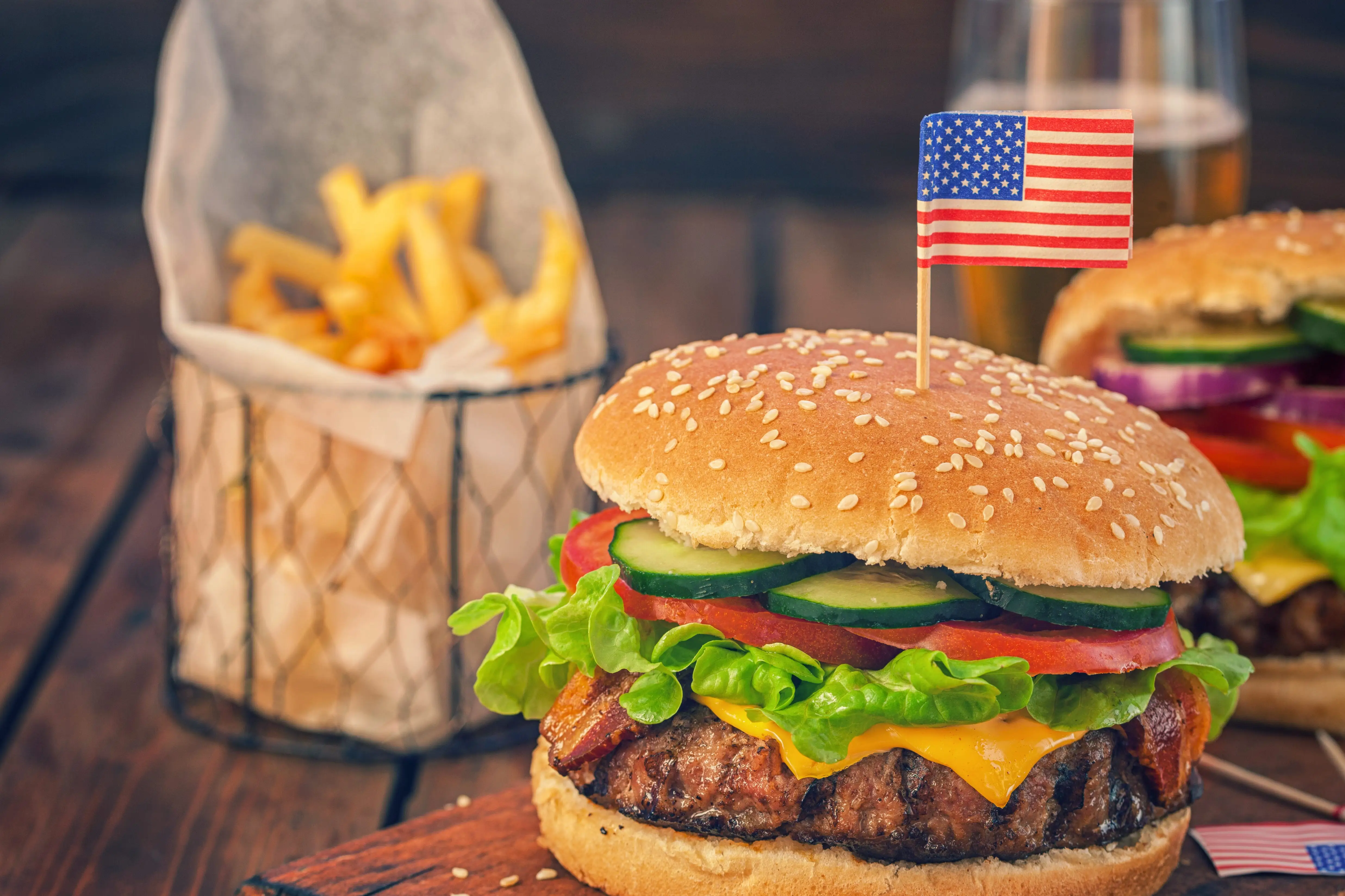a cheeseburger with an american flag toothpick