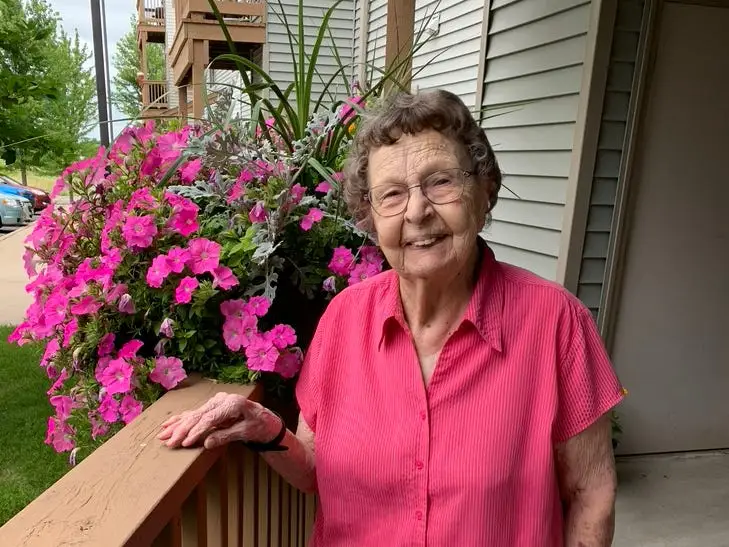 The author's grandmother wearing a pink shirt and khaki pants.
