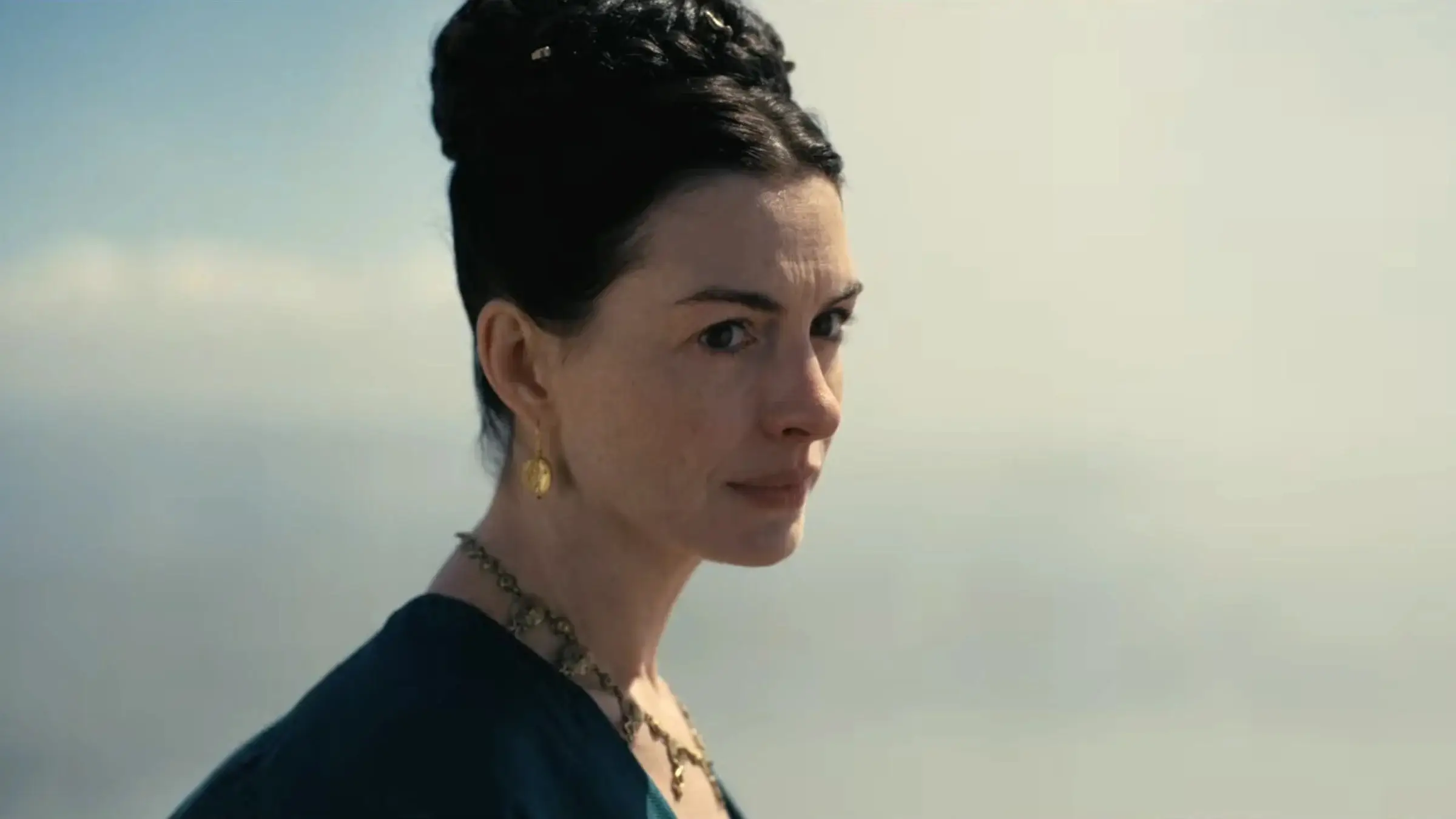 Anny Hathaway with hair up and gold earings in the Odyssey