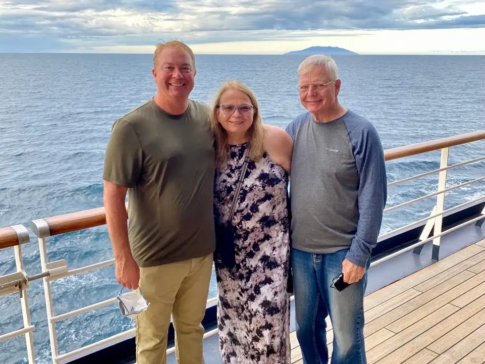 Three people smiling on cruise ship
