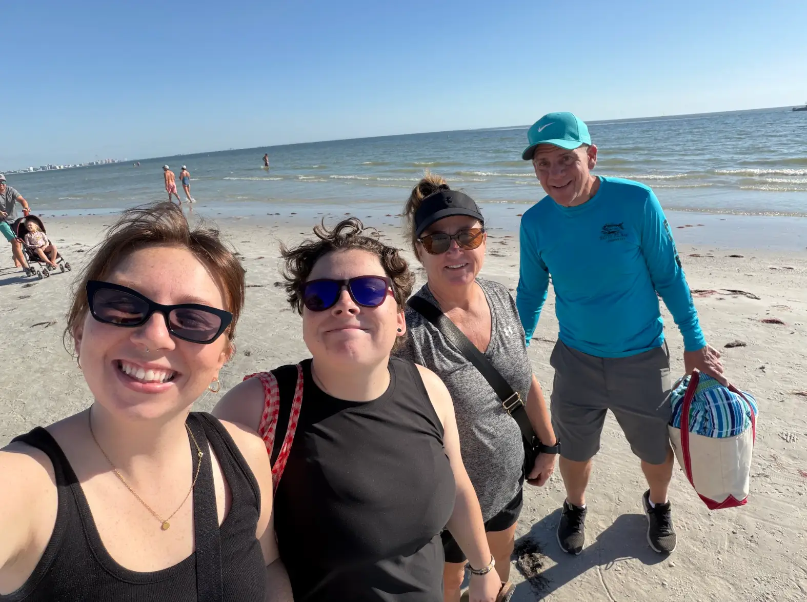 The writer, her partner, and her partner's parents at the beach.