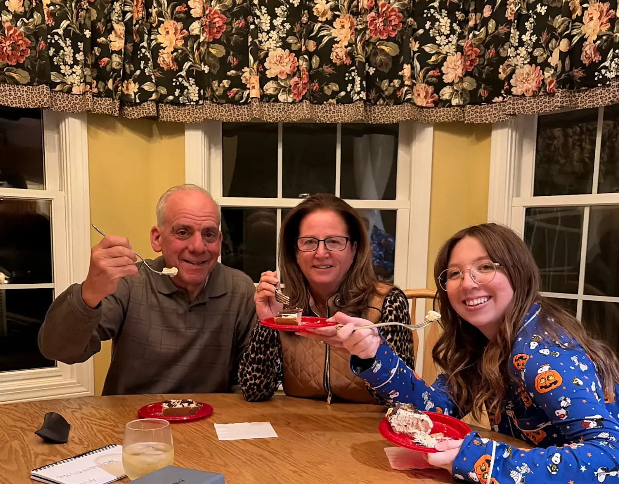The writer in her pajamas, eating pie with her partner's parents.