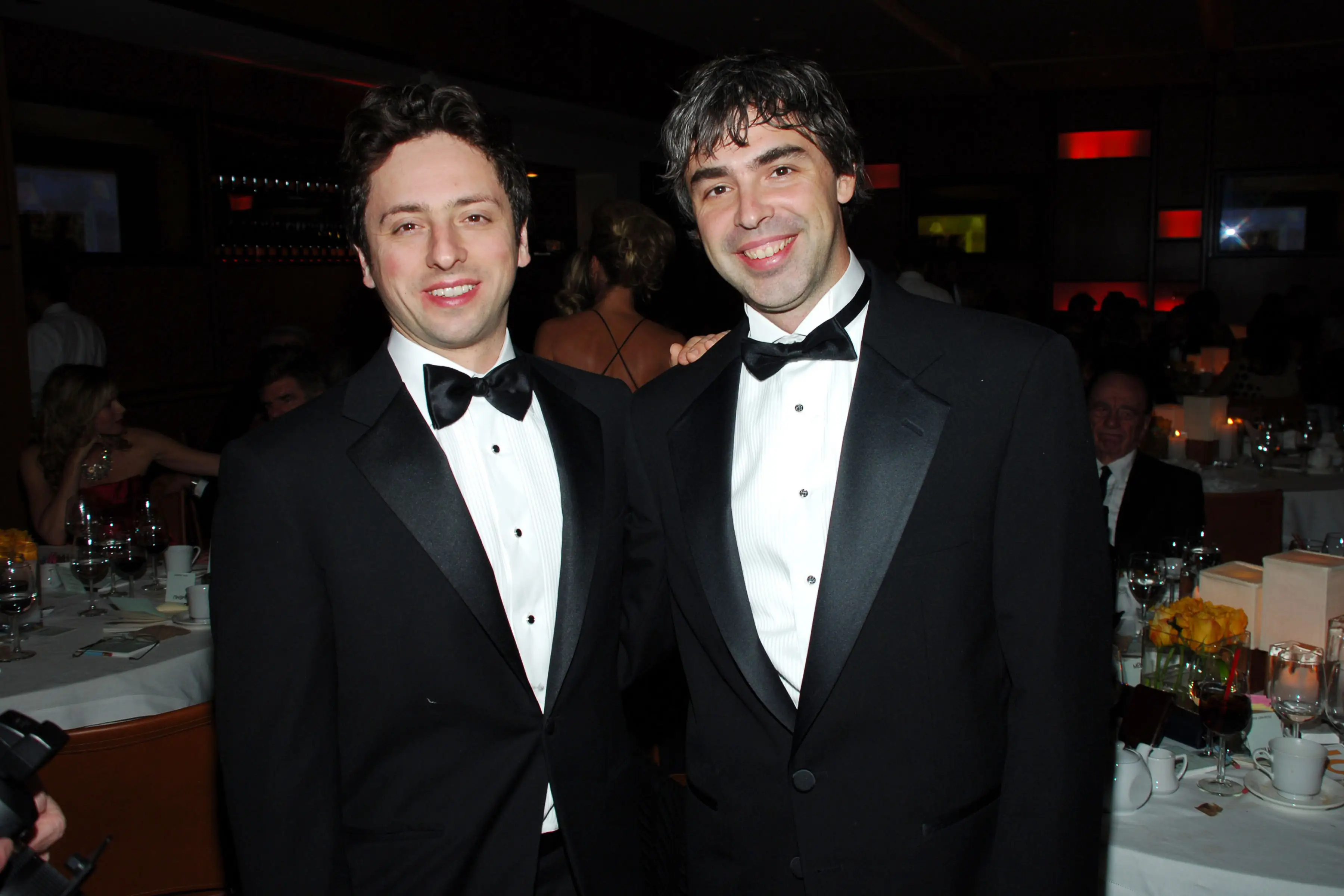 Sergey Brin and Larry Page dressed in tuxedos at a party