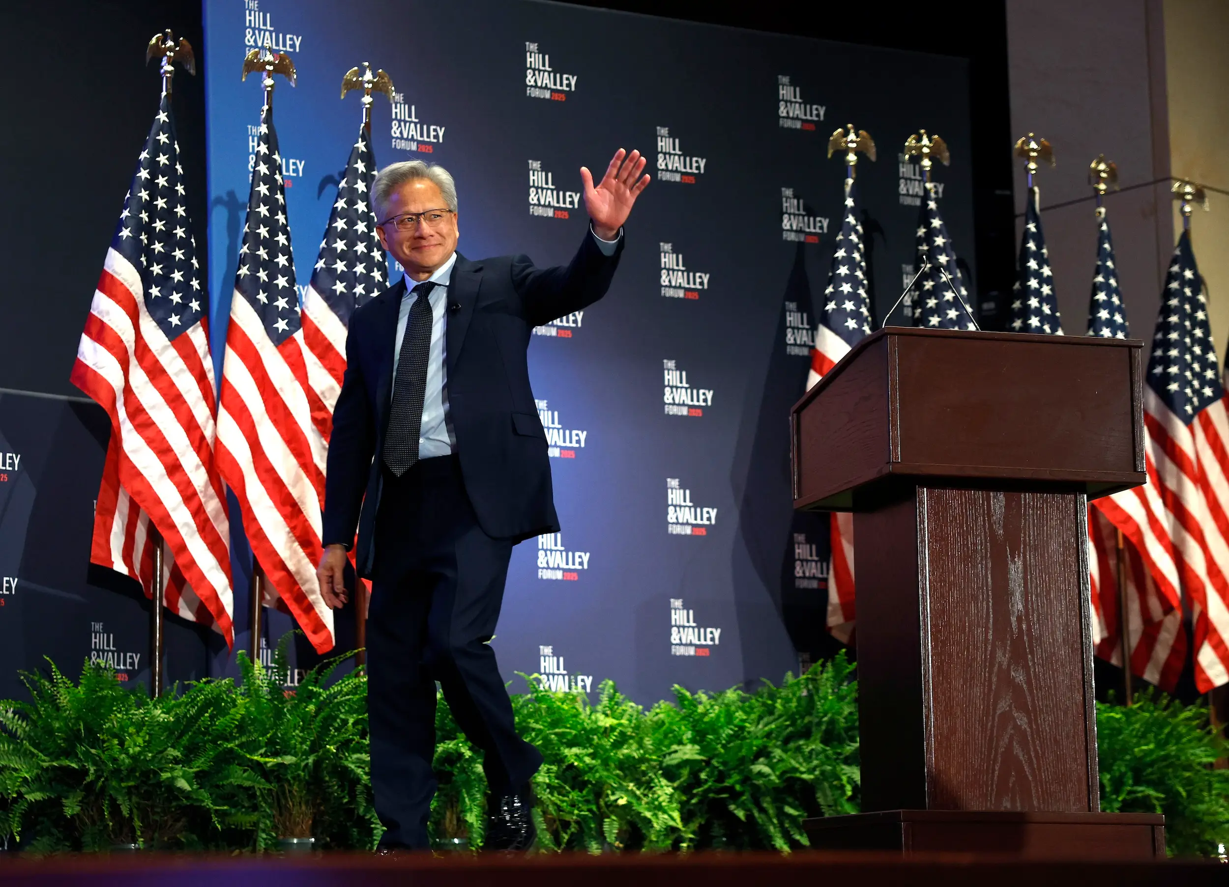 Jensen Huang waives as he leaves the stage at Hill & Valley Forum event