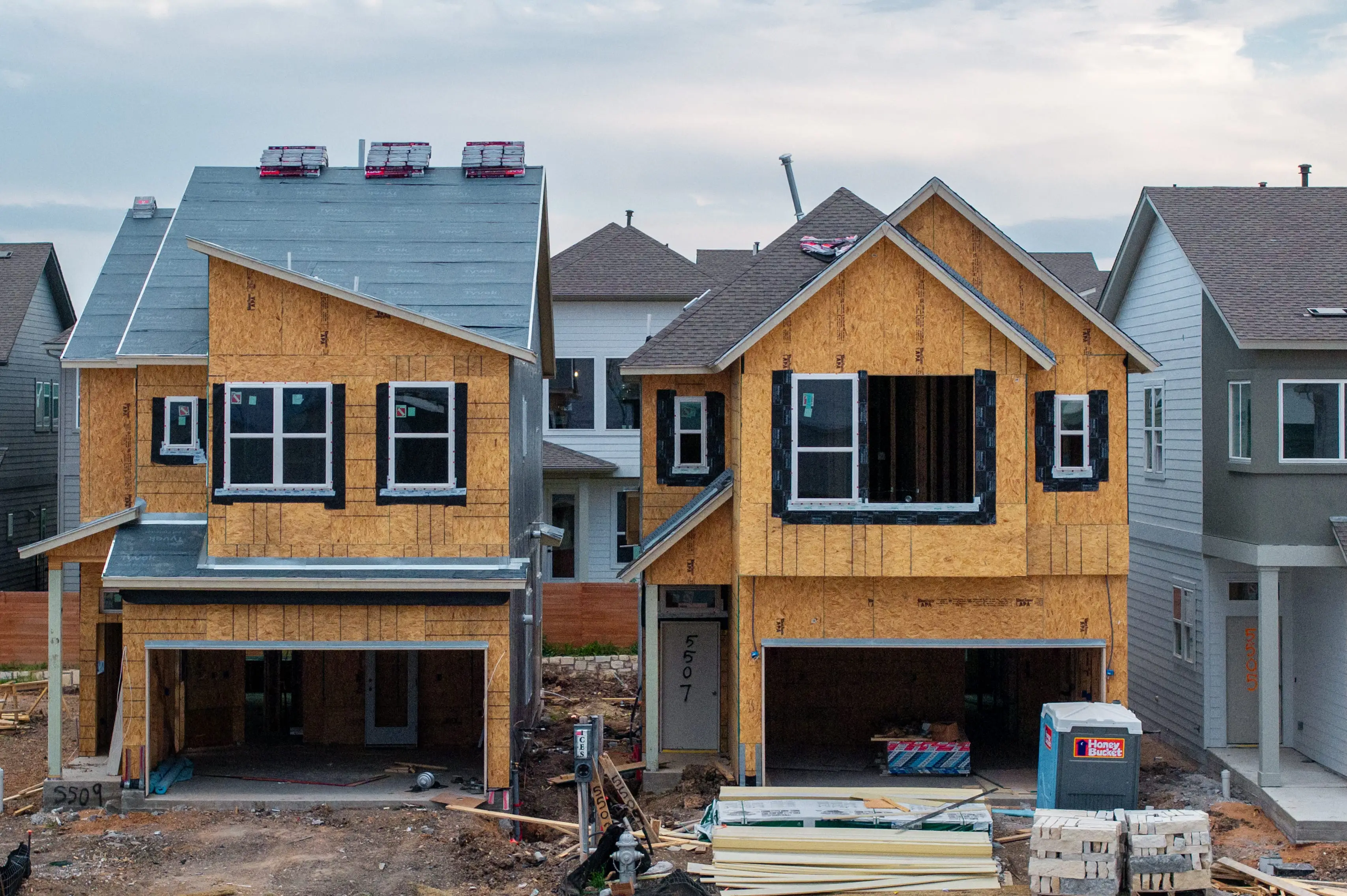 Two story homes being built in a Texas neighborhood.