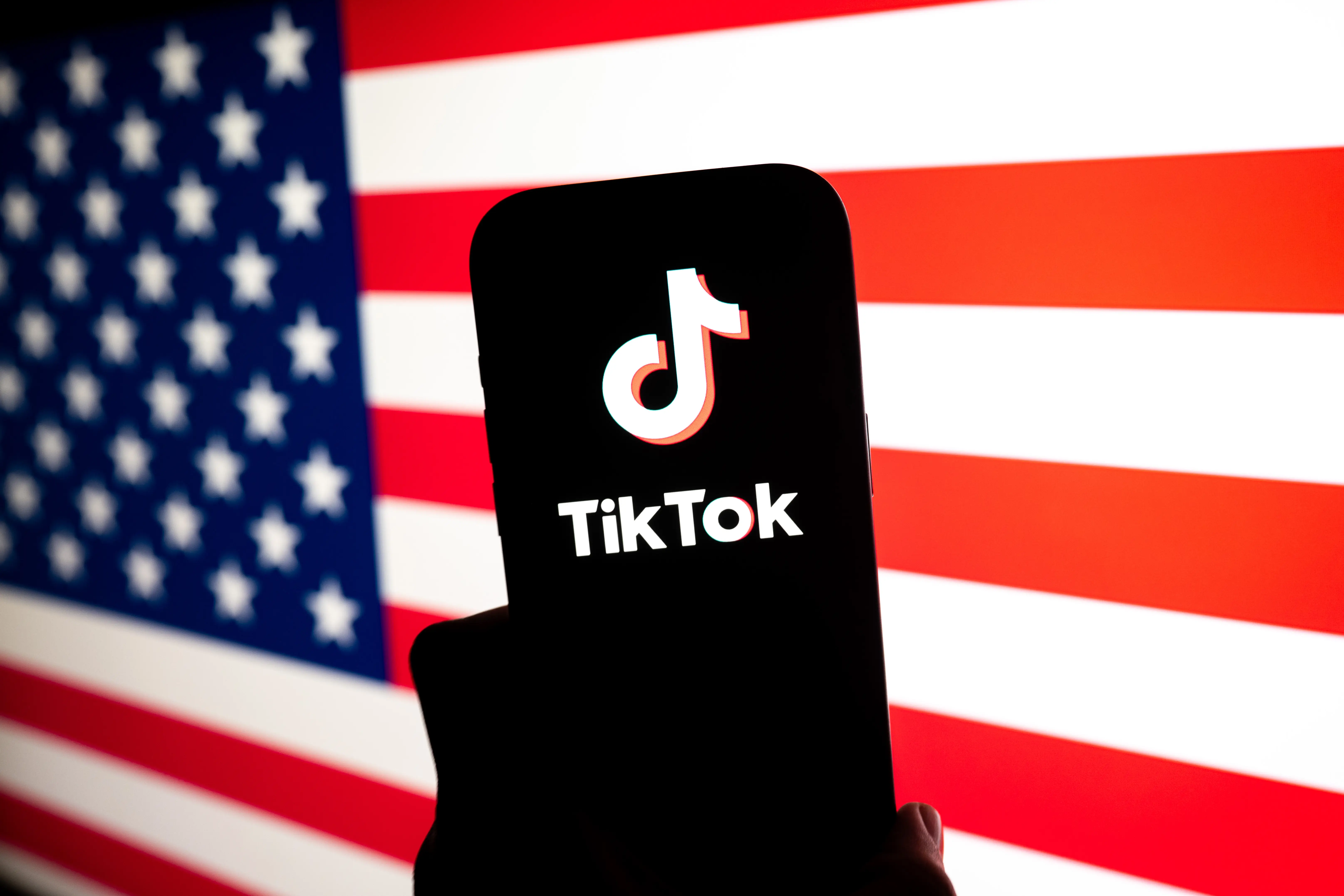 TikTok logo in front of a United States flag