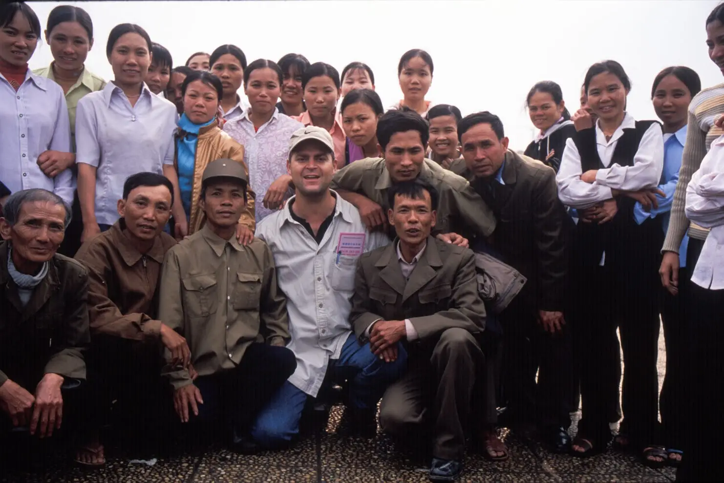 Kris LeBoutillier on assignment 25 years ago in Vietnam, posing with a group of locals near the Ho Chi Minh Mausoleum in Hanoi.