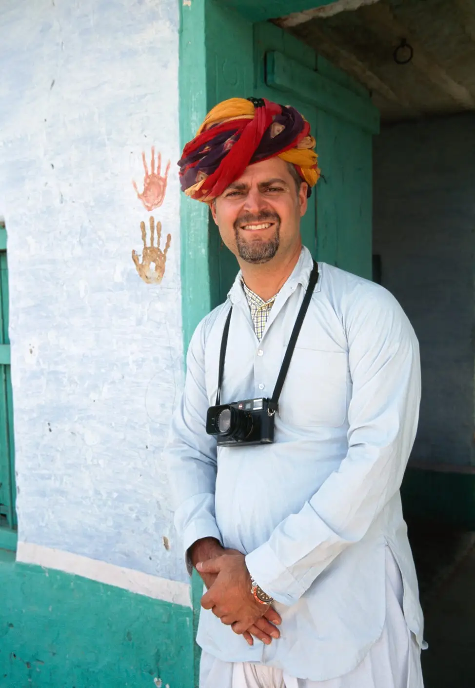 Kris LeBoutillier posing with a camera in Rajasthan, India.