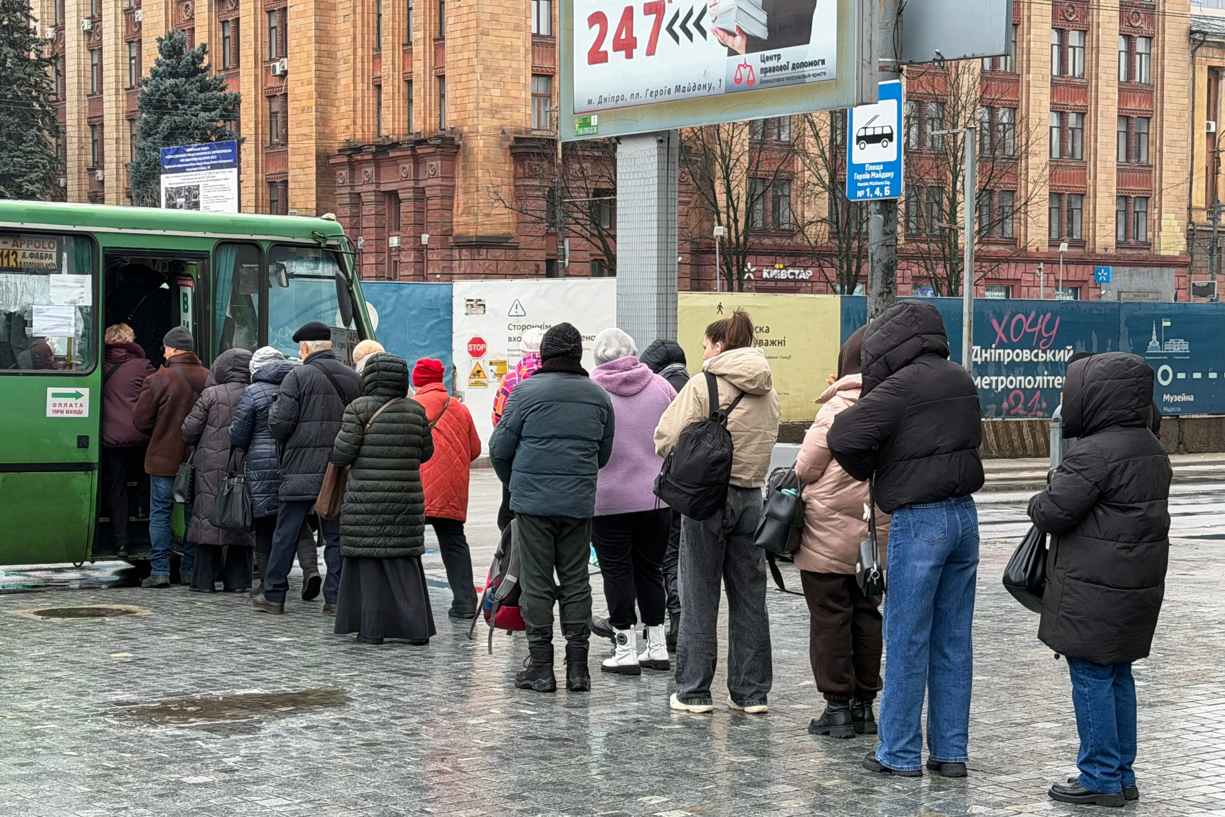 Ukrainian residents queue up for the bus.