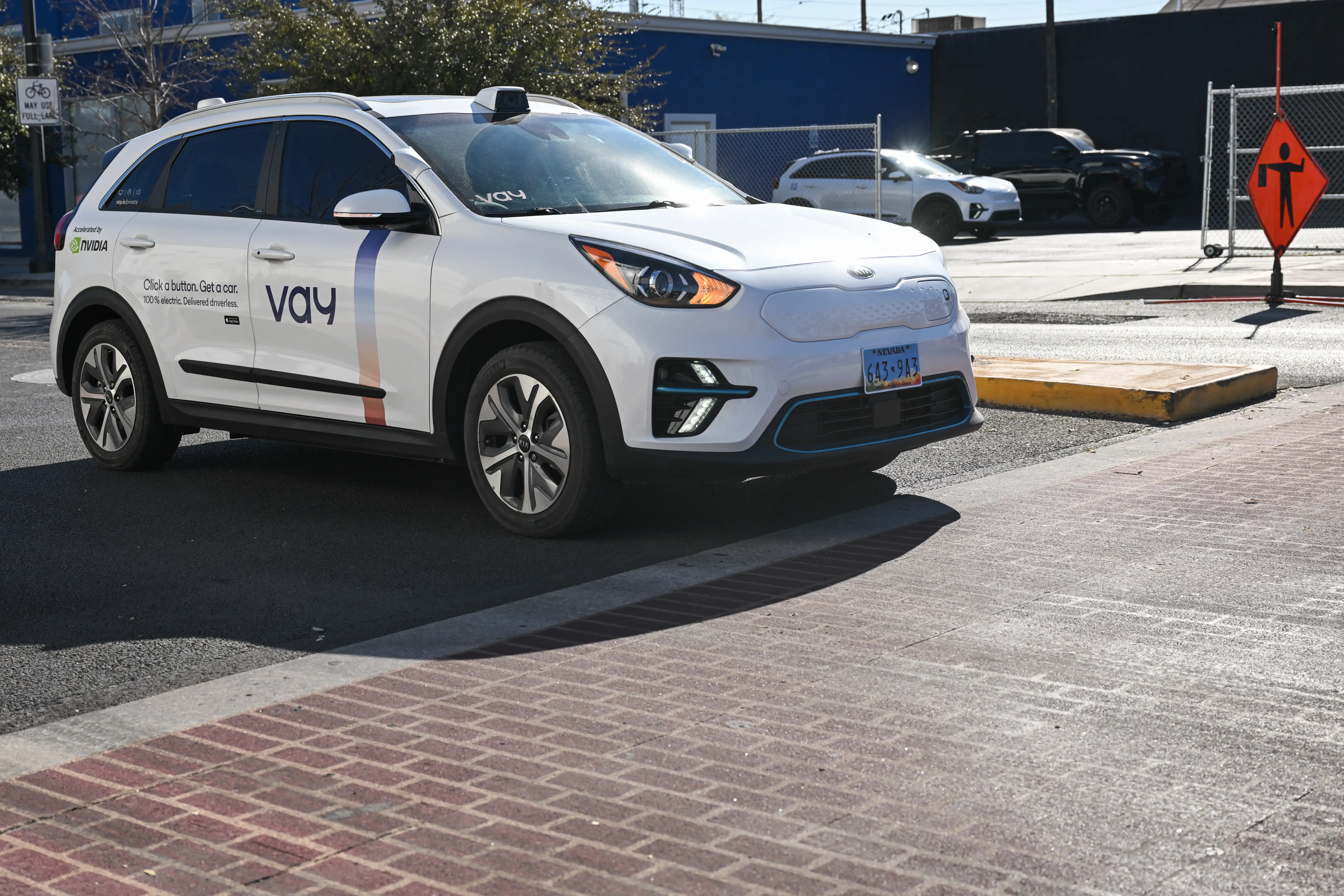 A Kia Vay remote-drive electric vehicle cruises during a live demonstration of remote driving on city streets ahead of the Consumer Electronics Show (CES).
