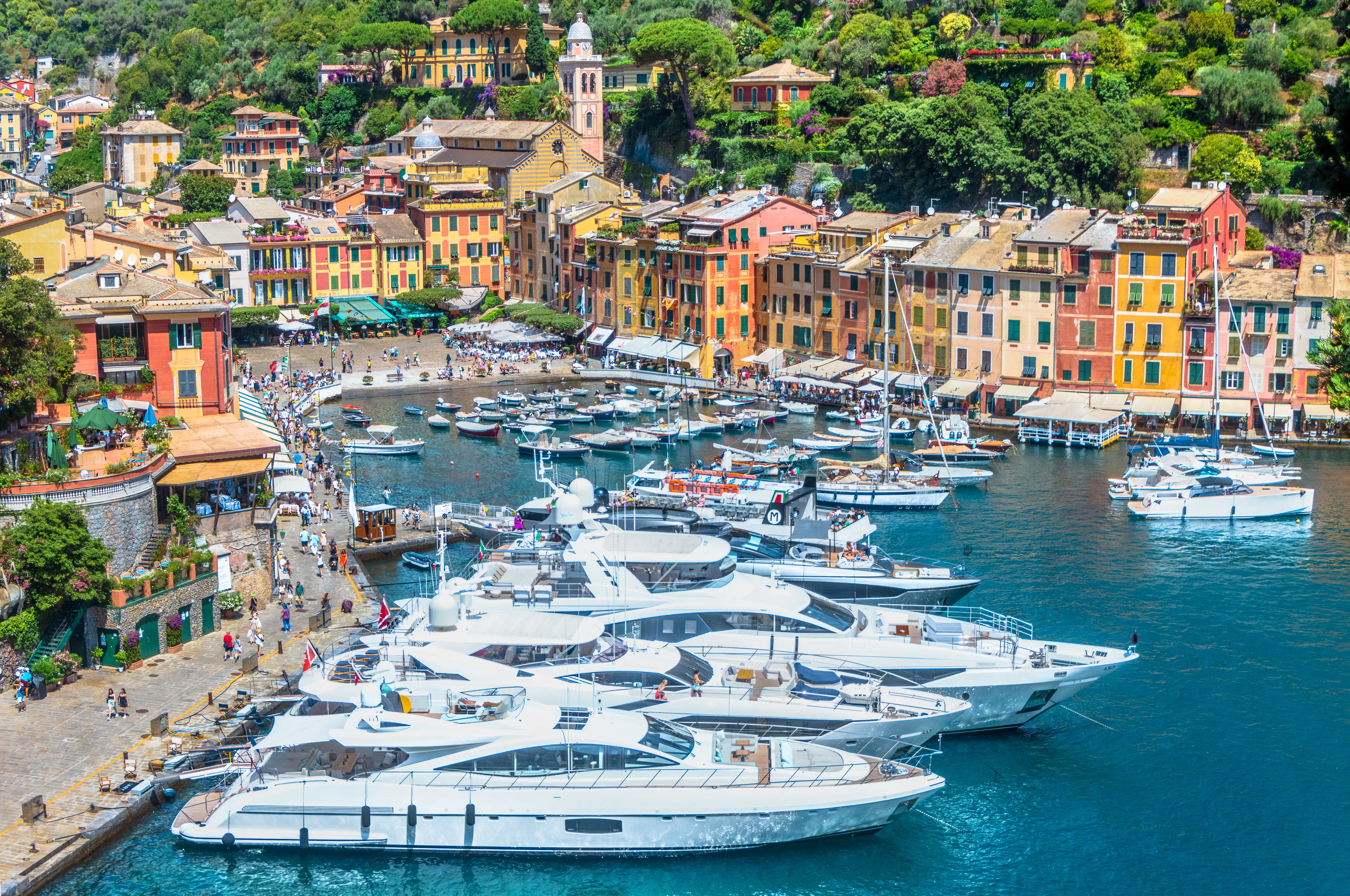 Yachts in front of colorful buildings in Portofino, Italy.