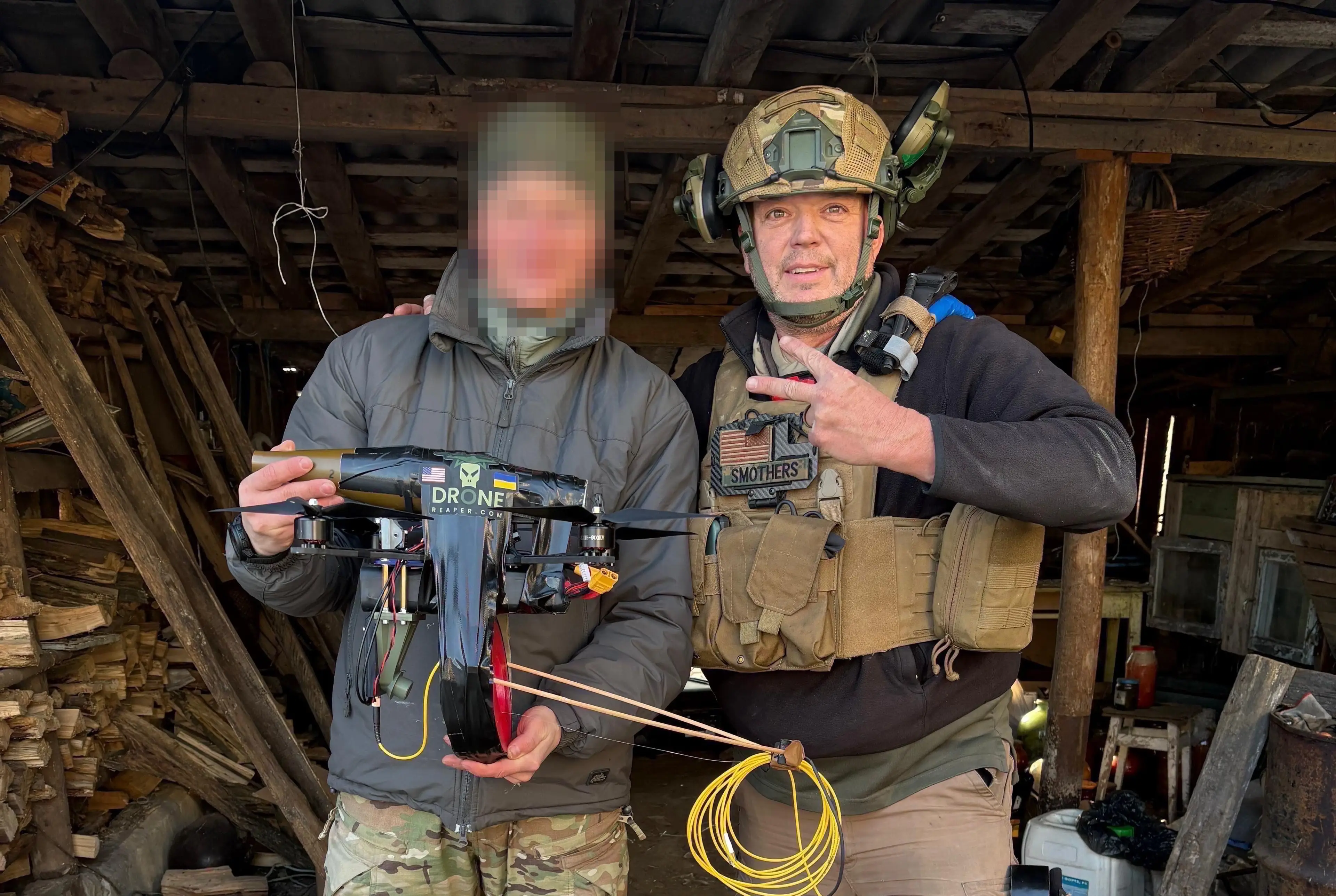 Troy Smothers poses with a Ukrainian holding a fiber optic drone.