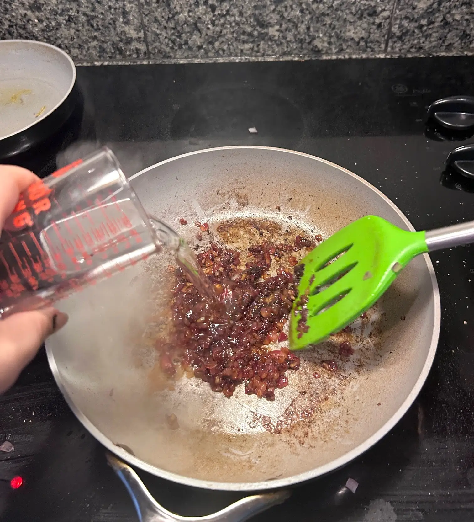 Adding vodka to onions for Gordon Ramsay's Bloody Mary Pasta