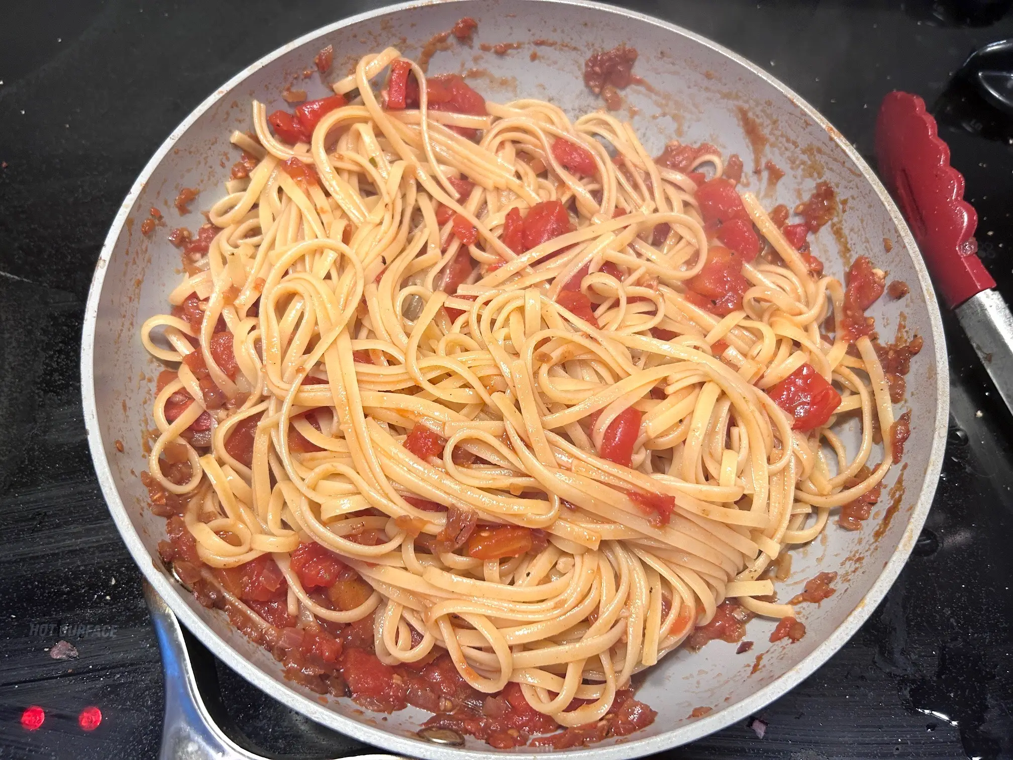 Mixing noodles into sauce for Gordon Ramsay's Bloody Mary Pasta
