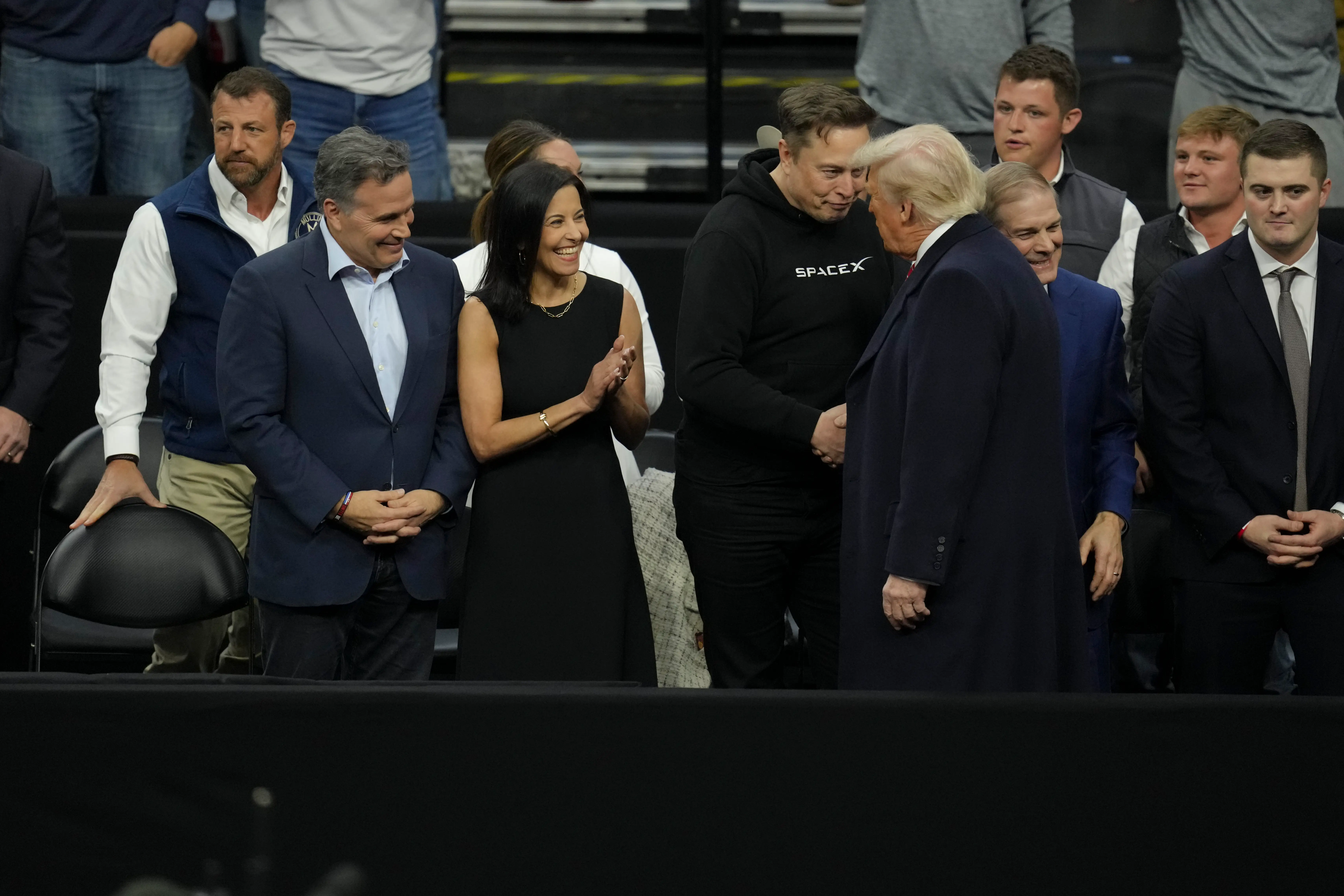 Donald Trump, Elon Musk, and Dina Powell McCormick are pictured at an NCAA wrestling match.