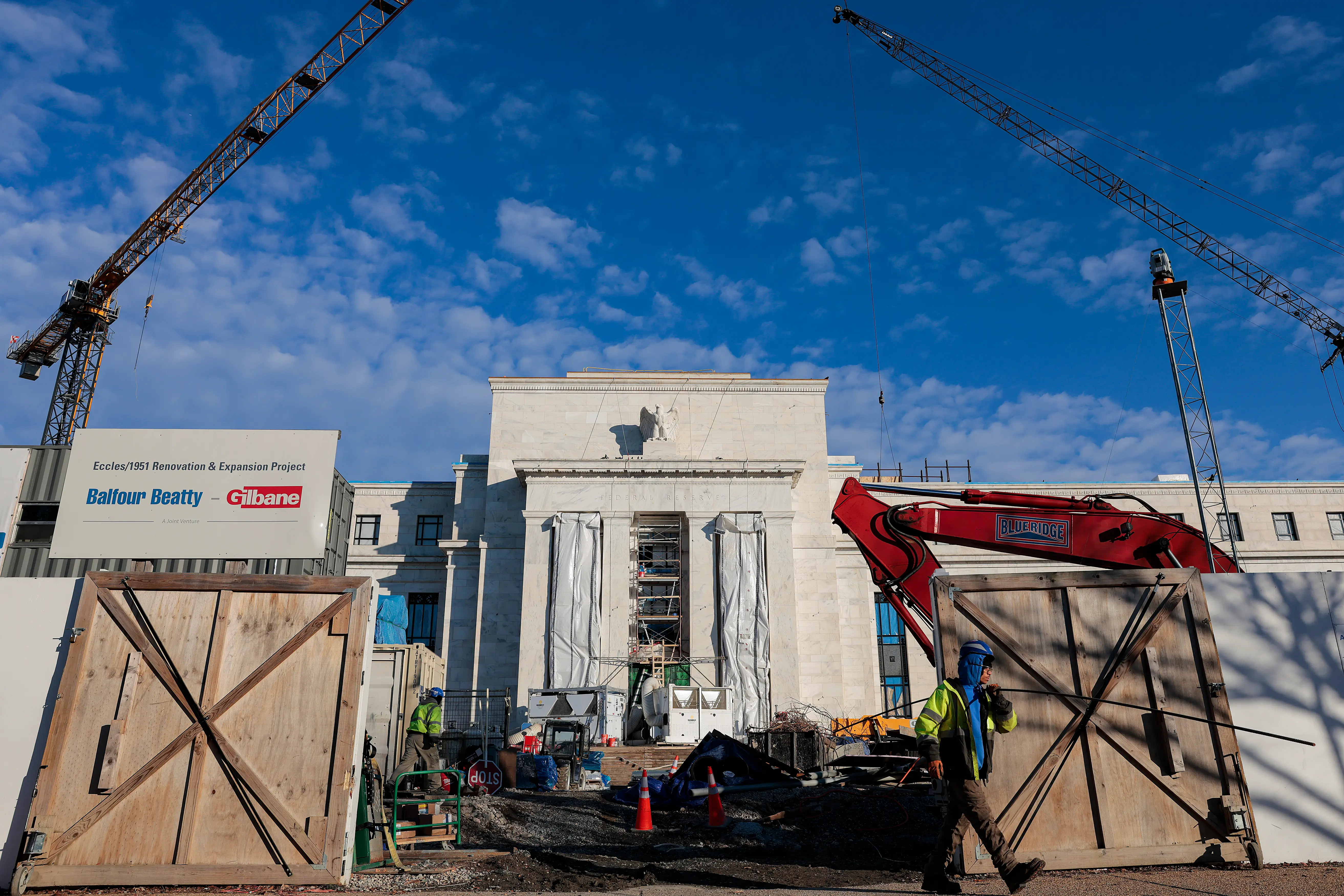 A worker exits the construction zone surrounding the Federal Reserve Bank's main Washington D.C. offices.