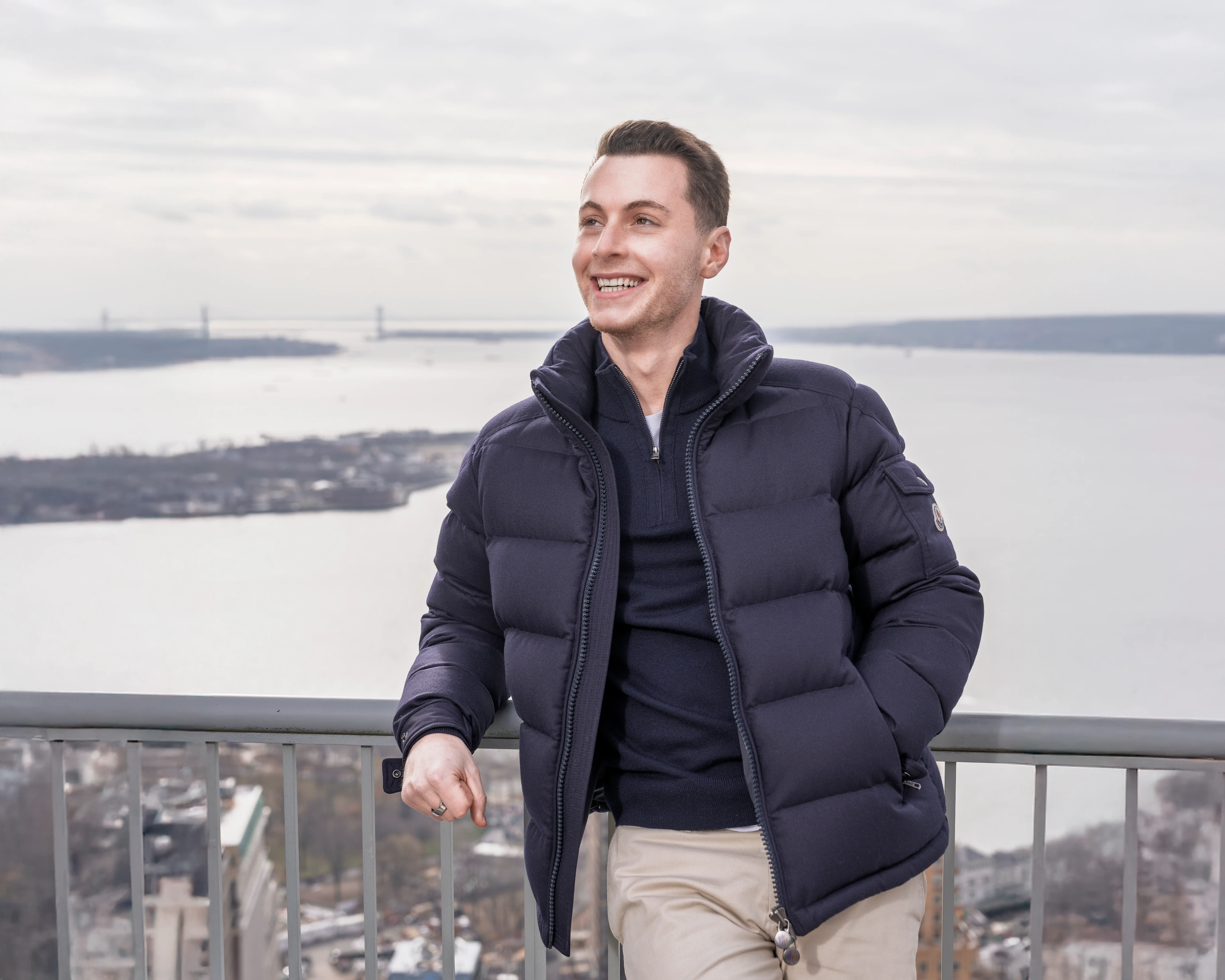 Oscar Rachmansky outside in coat with rive in the background.