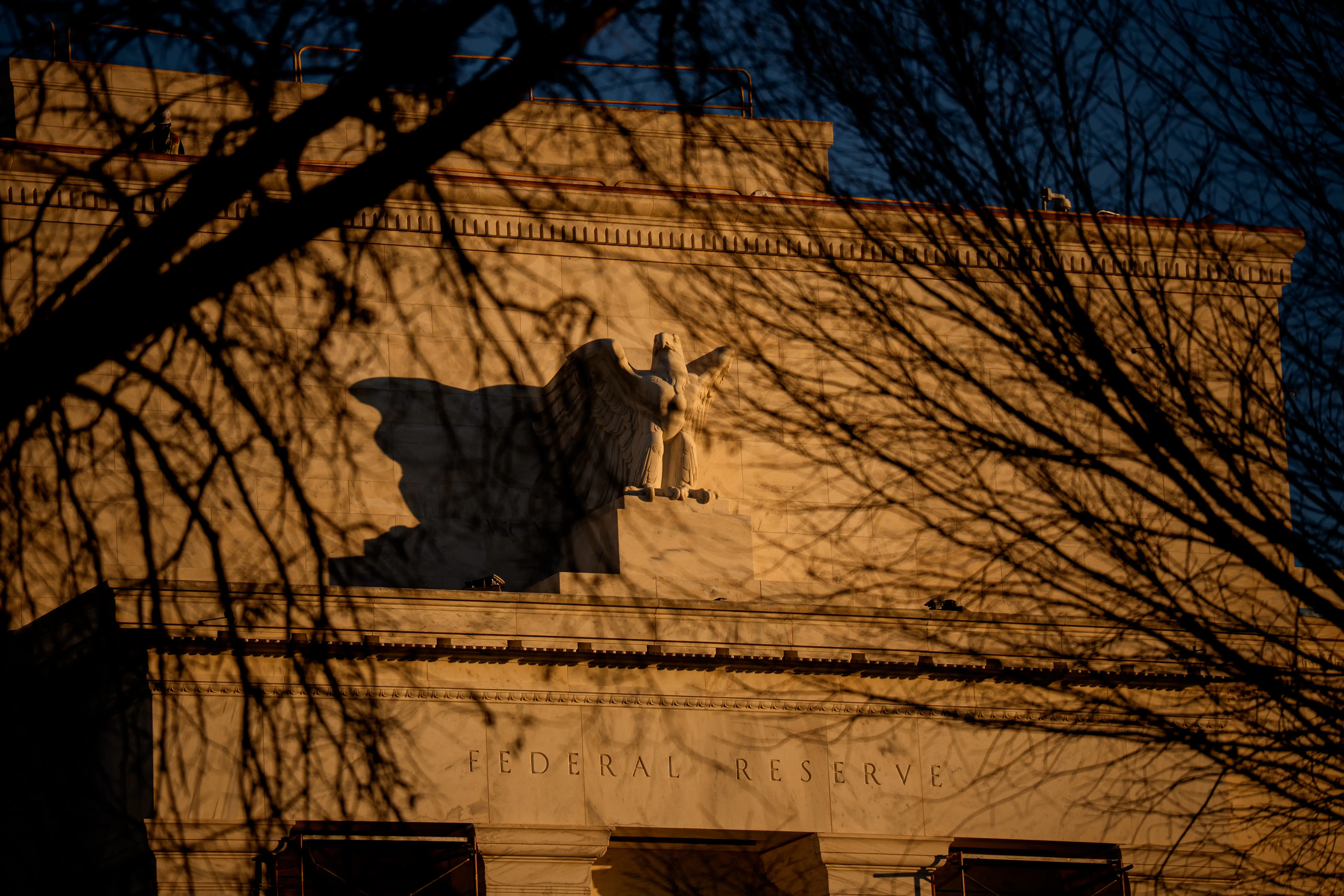 A statue of a bald eagle perched on top of the Eccles building.