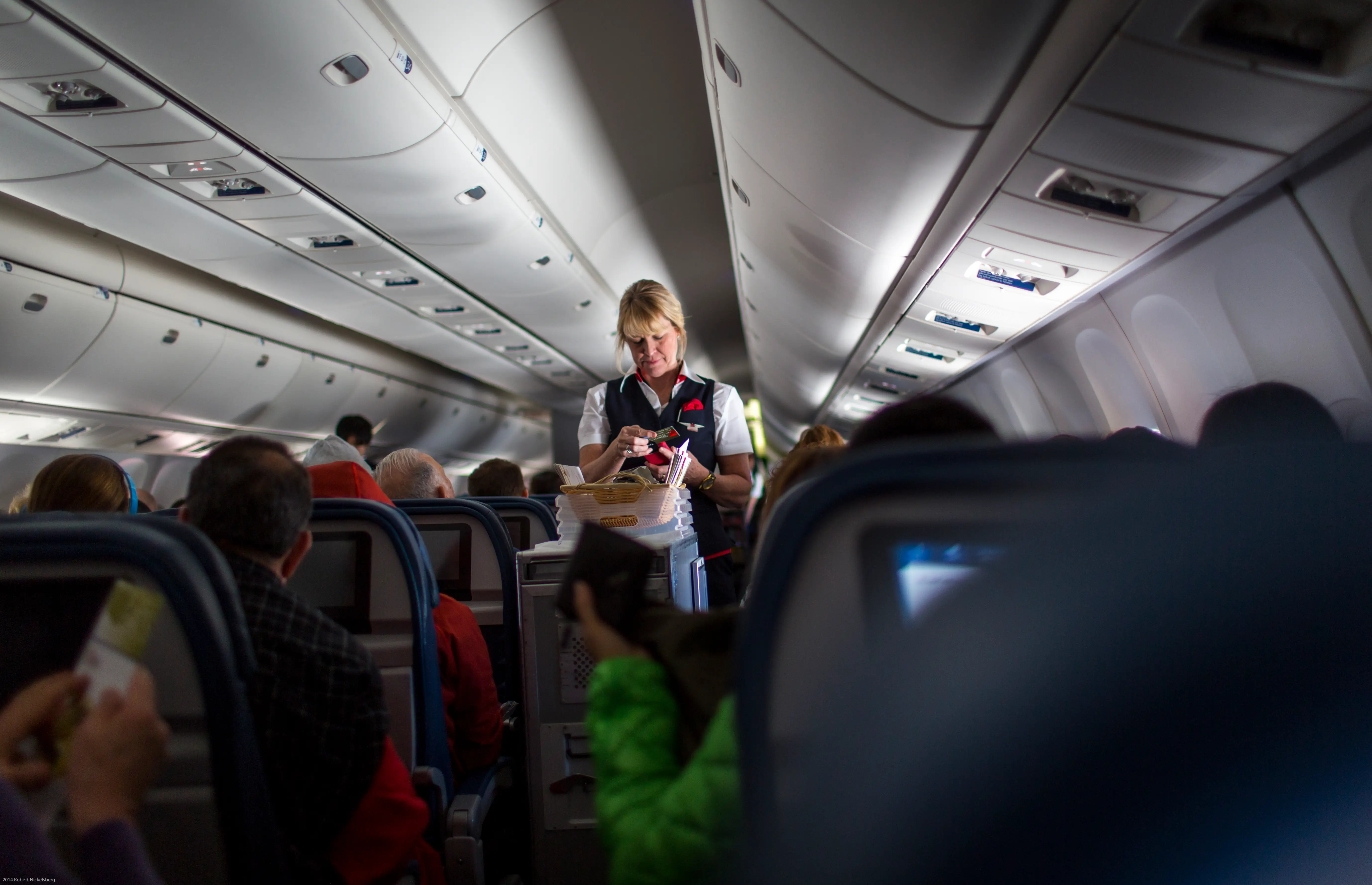 Delta flight attendant on a plane.