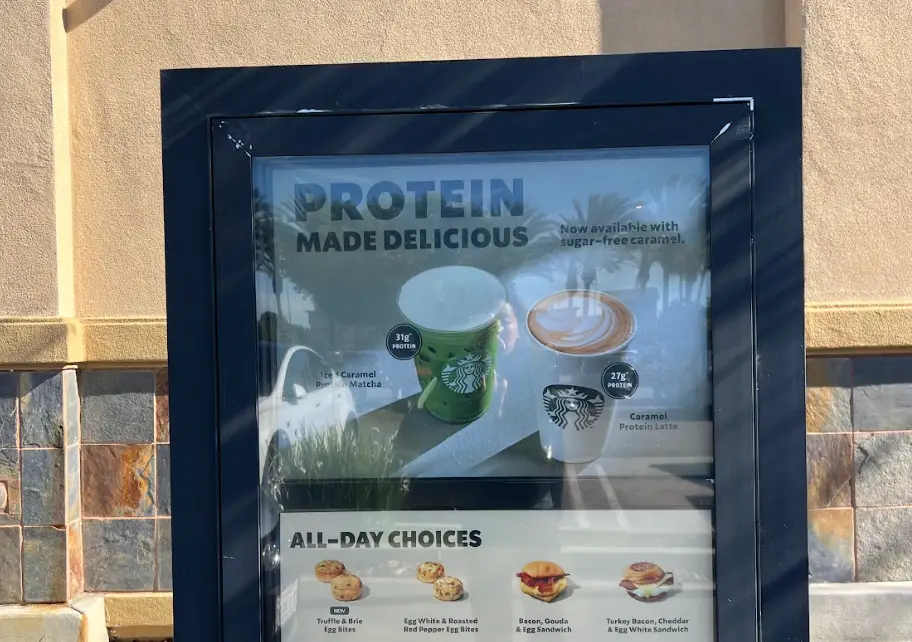 A drive-thru board advertising Starbucks' new protein drink options.