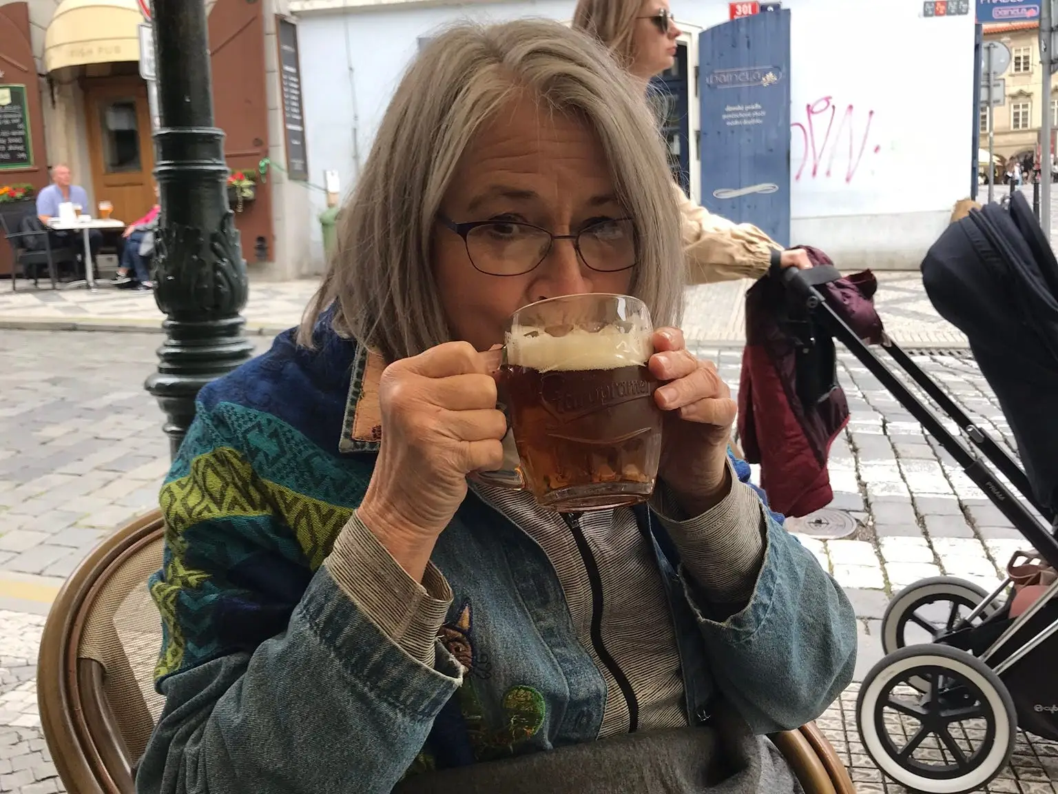 A woman drinking a pint of beer.