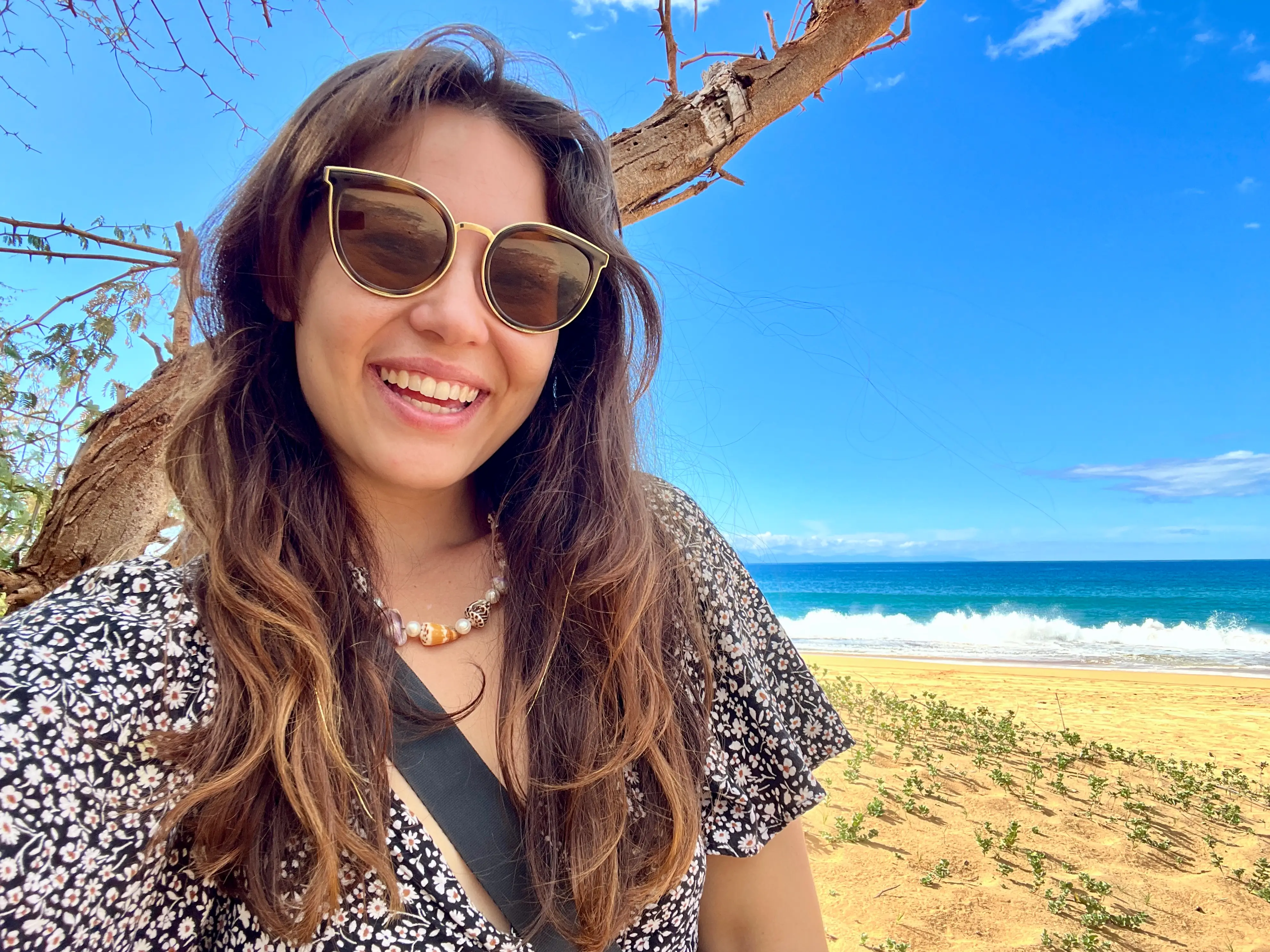 Author Ashley Probst smiling on empty beach in Hawaii
