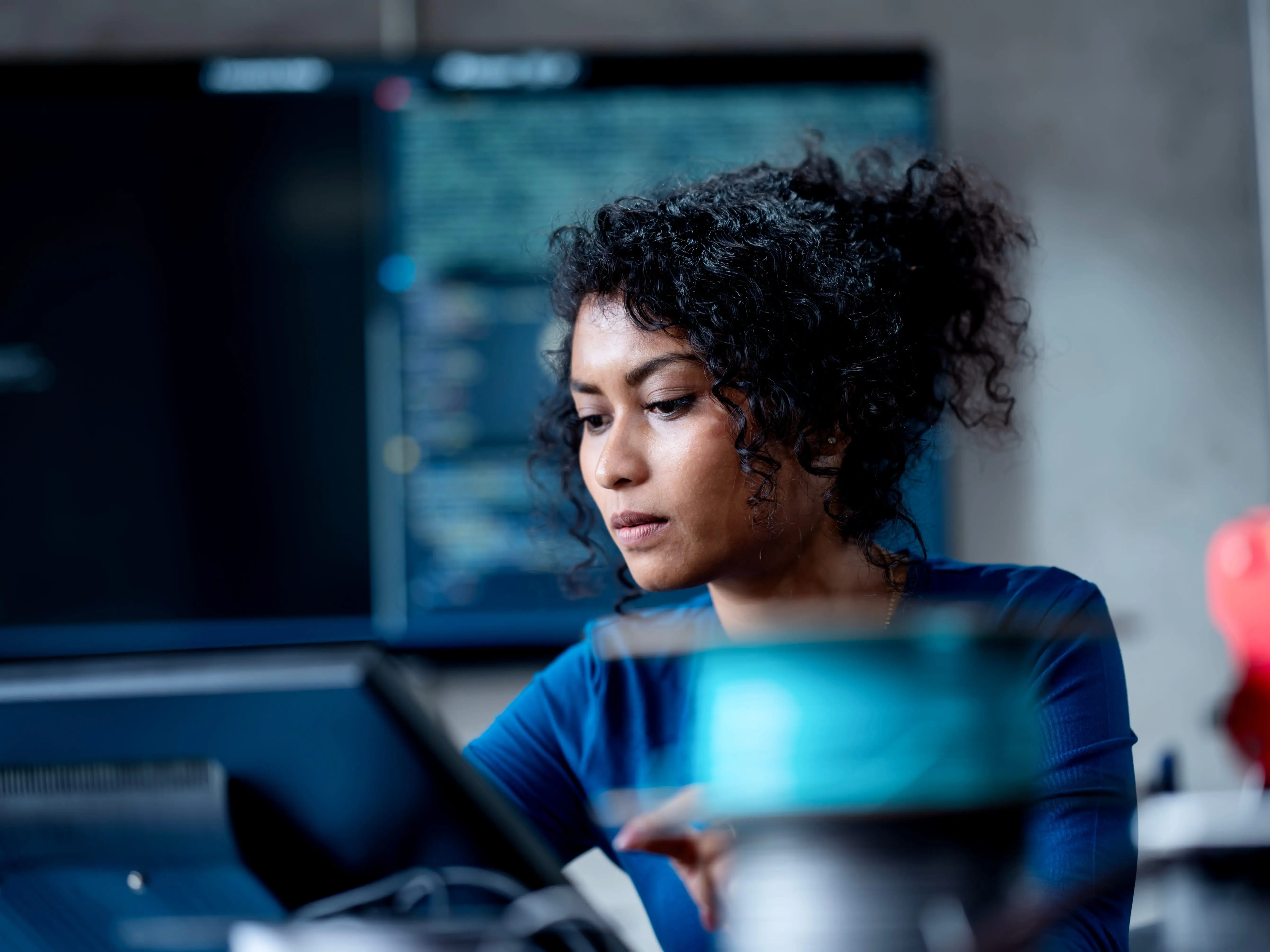 A person wearing a blue shirt is working
