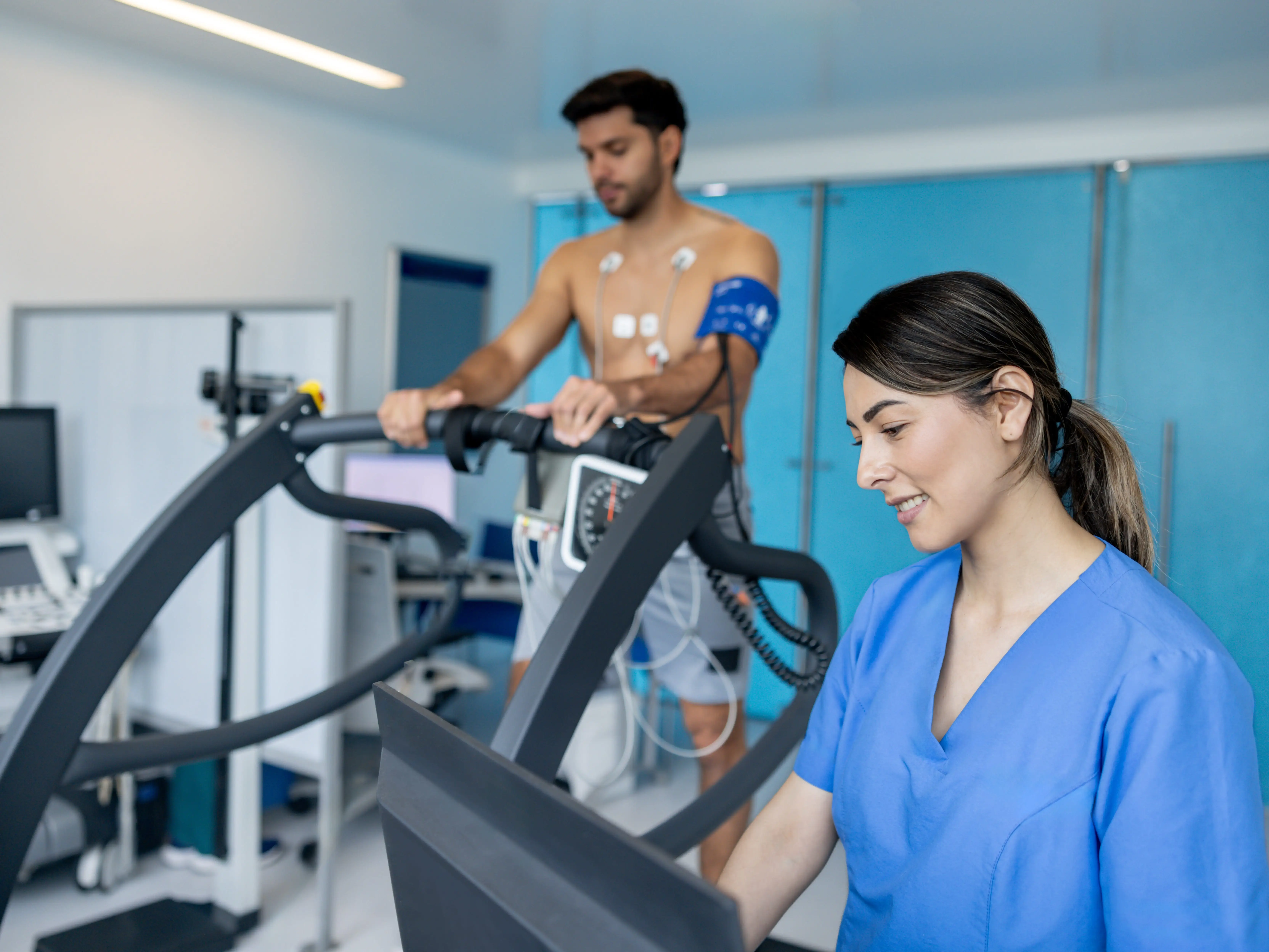 A healthcare professional with a patient doing the stress test