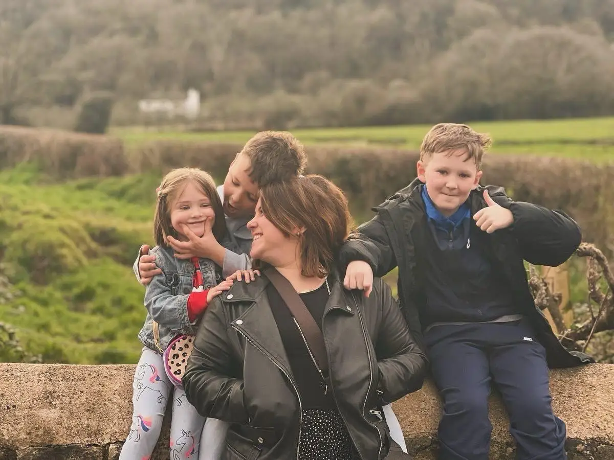 Mom with three kids posing for photo