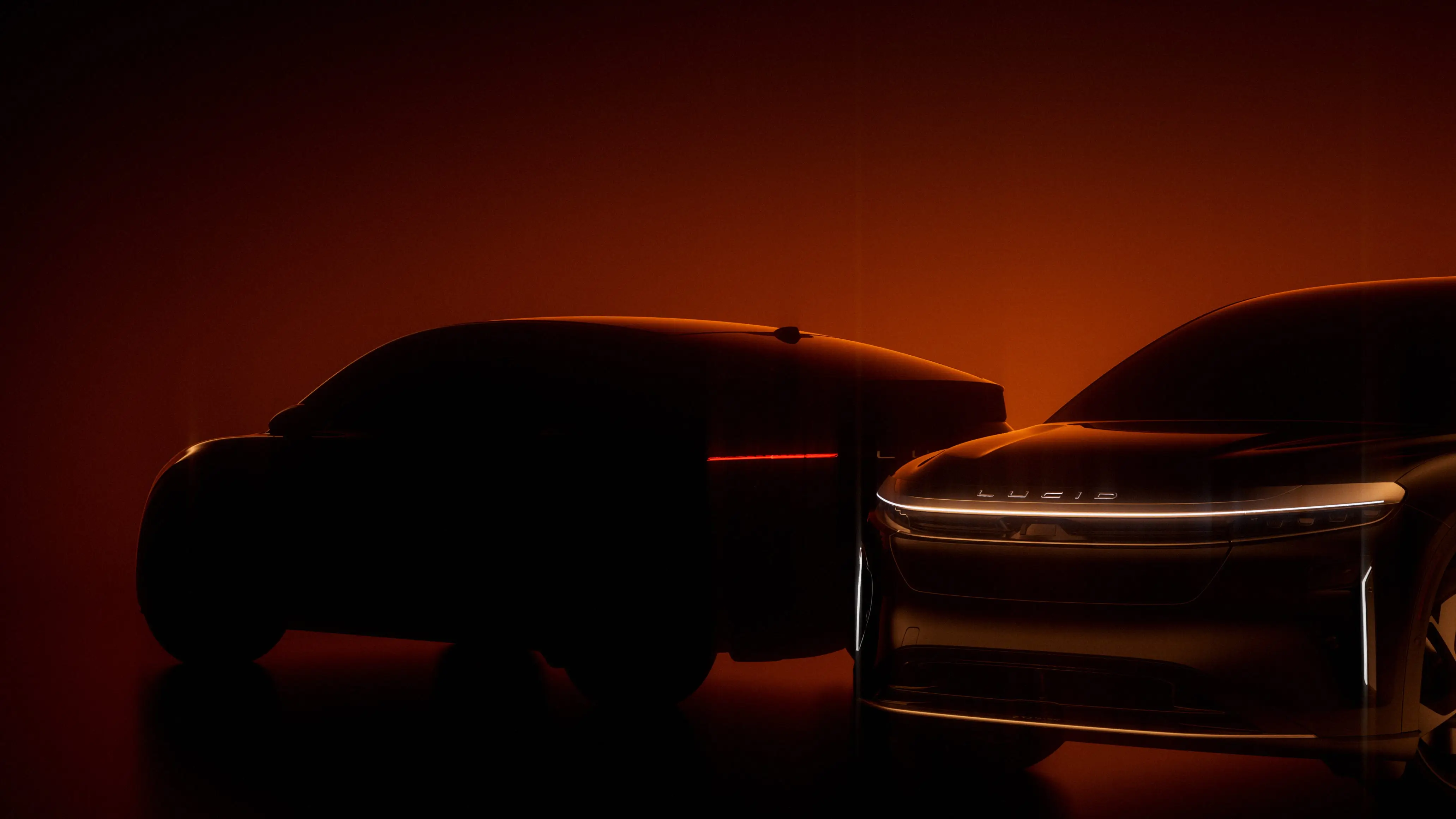 A darkened image of Lucid's blurred-out mid-size SUV.