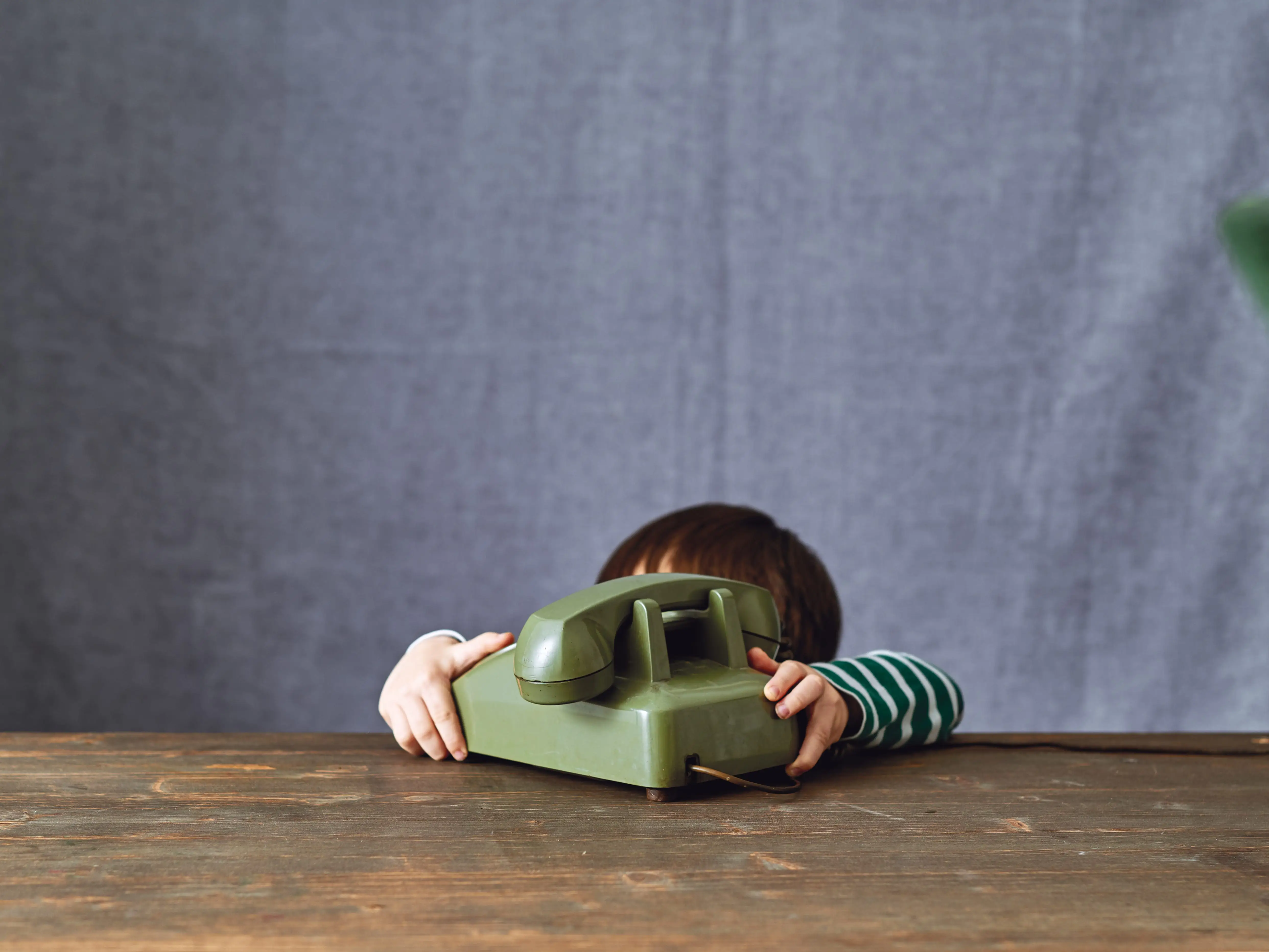 Cute child using phone retro style. 2-3 years child talking on retro style phone