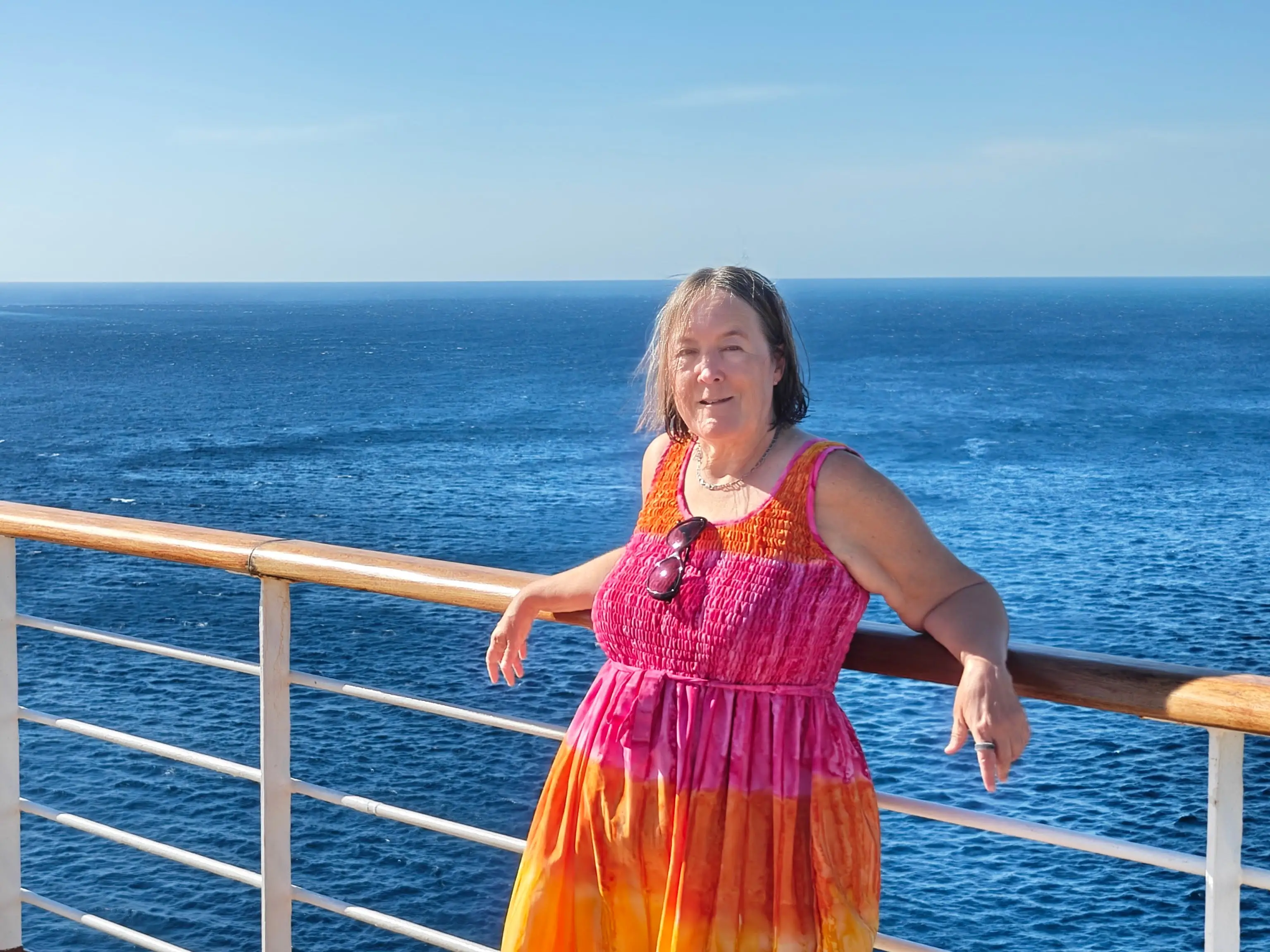 Sharon poses on the deck of a cruise ship.
