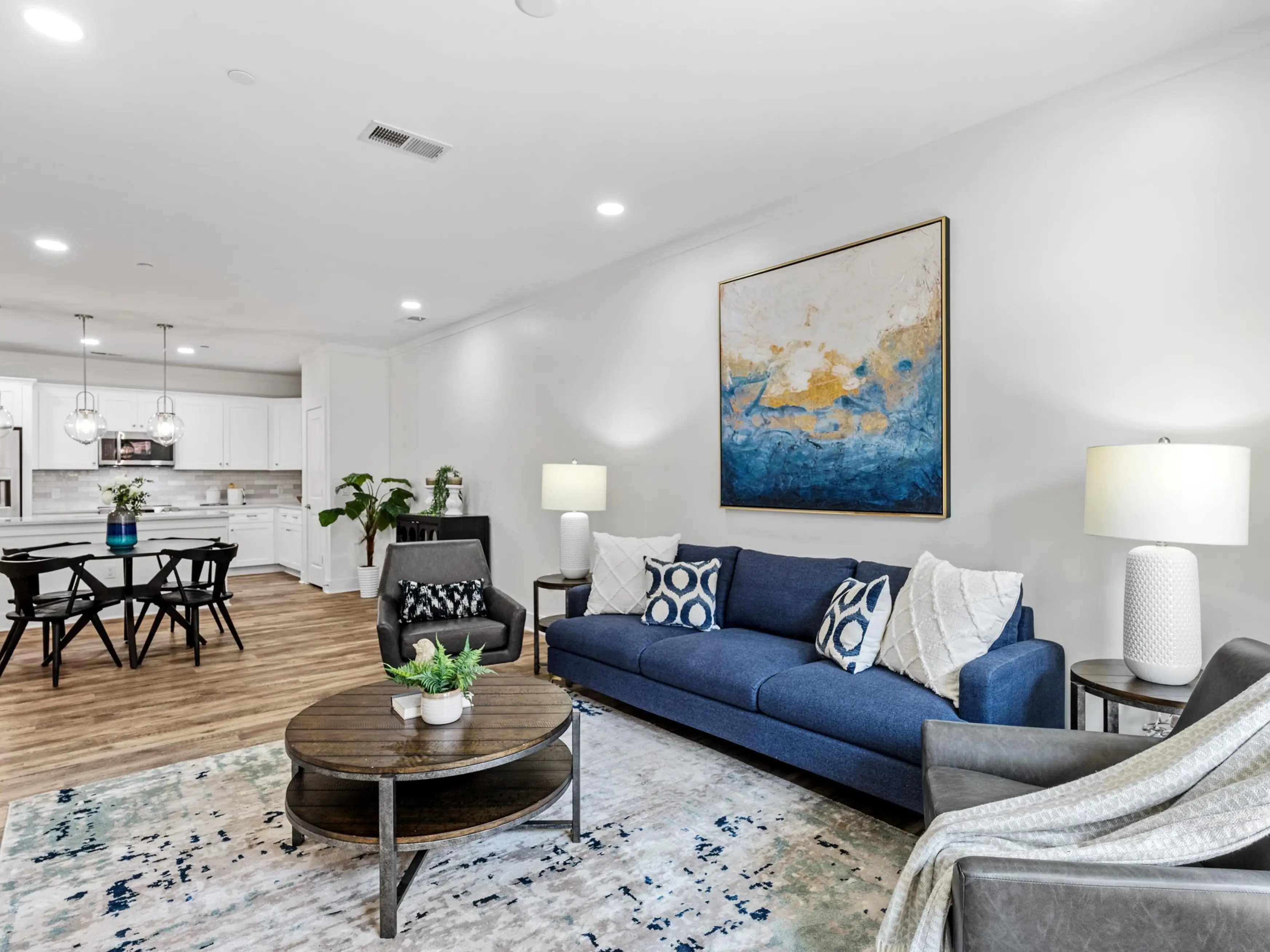 Living room with round coffee table, blue couch